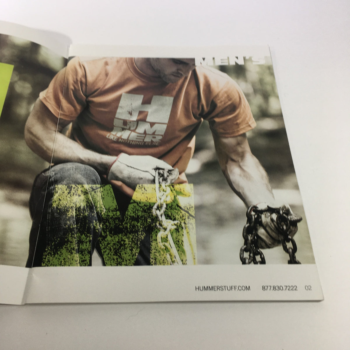 Interior page of the 2009 Hummer Apparel and Accessories Brochure Catalog showcasing a man wearing a Hummer t-shirt while gripping a chain.