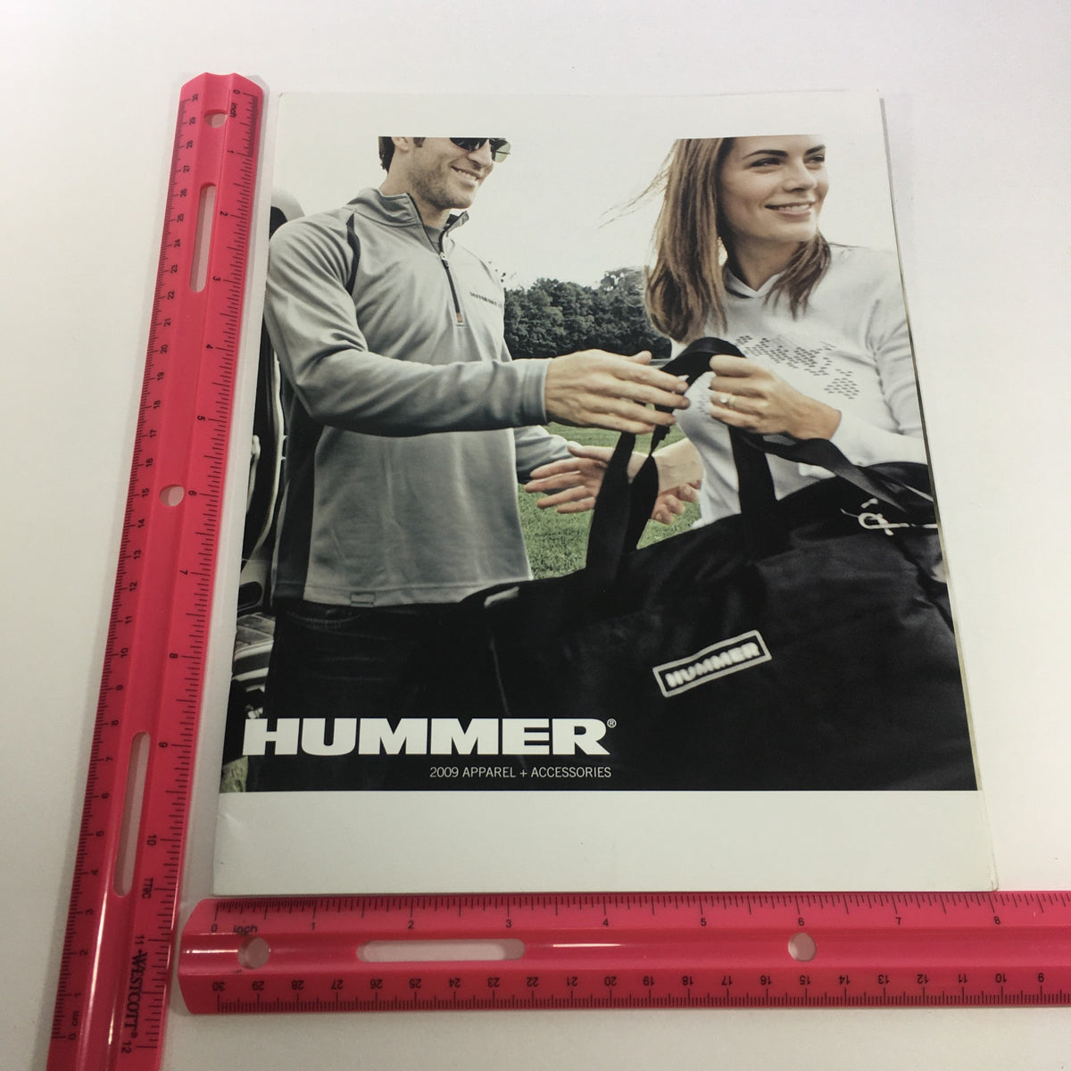 Front cover of the 2009 Hummer Apparel and Accessories Brochure Catalog featuring two models showcasing branded apparel and accessories.