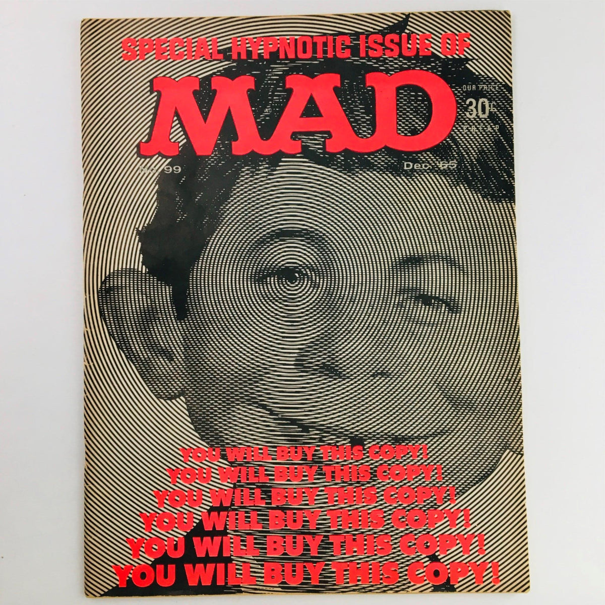 Mad Magazine December 1965 No. 99 Special Hypnotic Issue cover featuring eye-catching hypnotic spiral artwork and text urging readers to buy the magazine, reflecting 1960s pop culture.