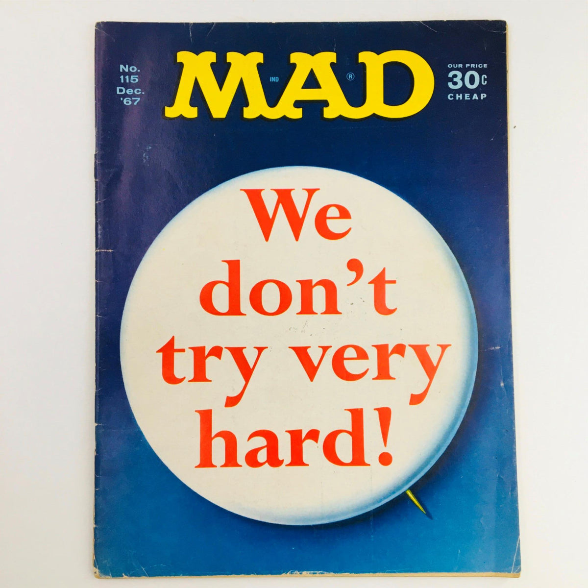 Cover of Mad Magazine December 1967 No. 115 featuring the bold text 'We don't try very hard!' against a blue background, showcasing the iconic style of the publication.