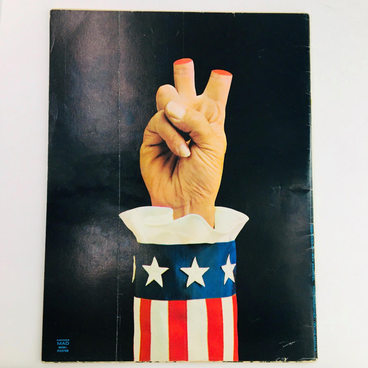 Back cover of Mad Magazine April 1973 No. 158 featuring an artistic depiction of a hand forming a peace sign, set against a dark background, emphasizing the magazine's engaging and humorous themes.