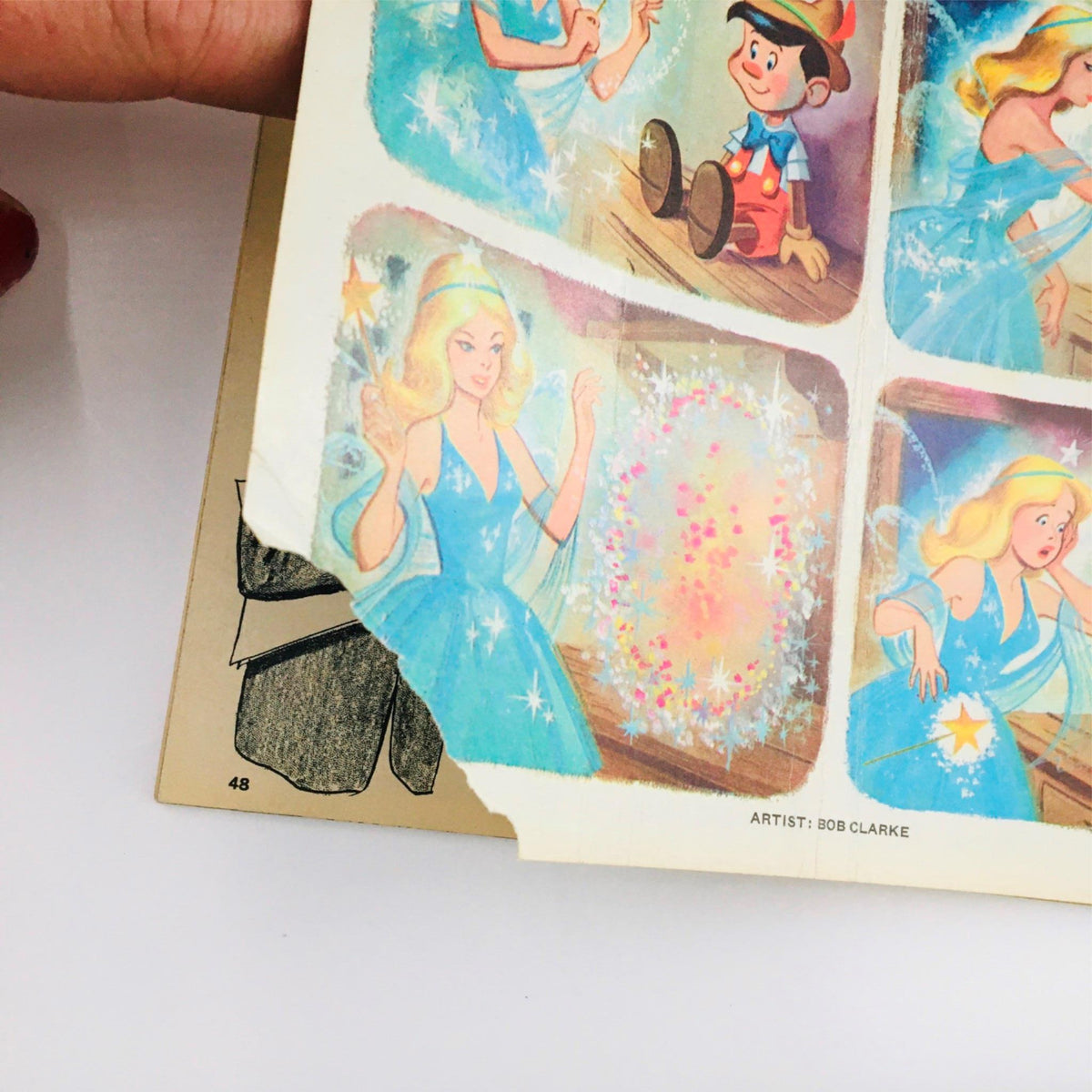 Close-up view of a vintage comic page from 'The Little Wooden Puppet', highlighting art by Bob Clarke, featuring enchanting scenes of Pinocchio and fairies, perfect for collectors.