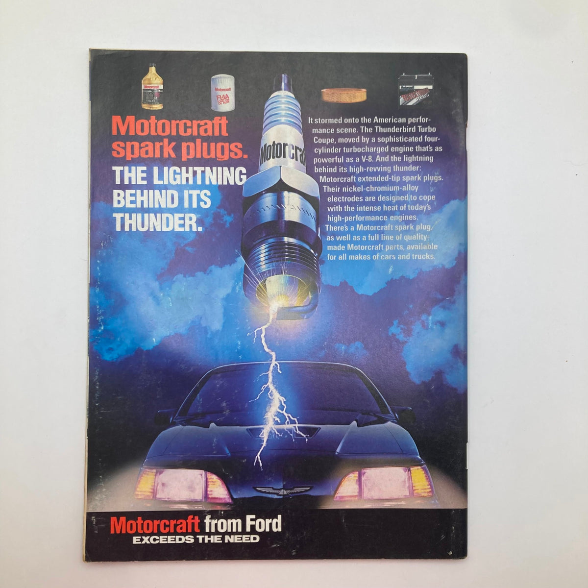 Back cover of the VTG Stock Car Racing Magazine June 1987 featuring an advertisement for Motorcraft spark plugs. This striking design incorporates a car and lightning motif, emphasizing high-performance parts for vehicles, perfect for automotive collectors.