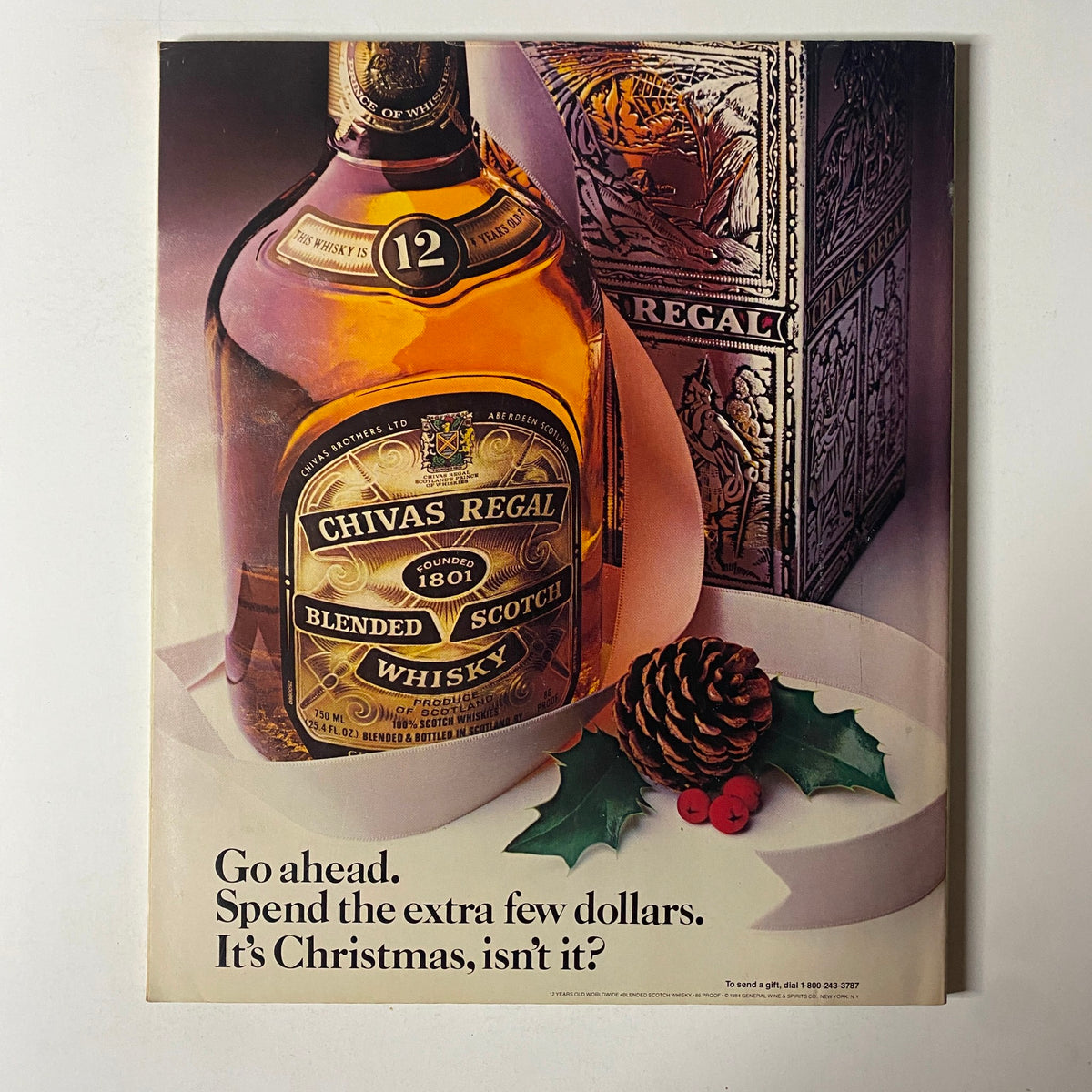 Advertisement for Chivas Regal Blended Scotch Whisky in Fortune Magazine, December 24, 1984, encouraging readers to spend more during the holiday season.