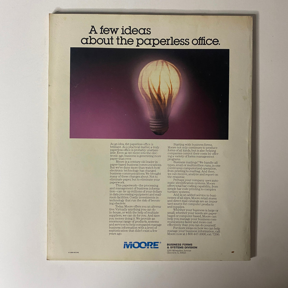 Back cover of Fortune Magazine June 23, 1986 with an advertisement discussing the concept of a 'paperless office'. The design features a lightbulb illuminating the idea of modern business efficiency.