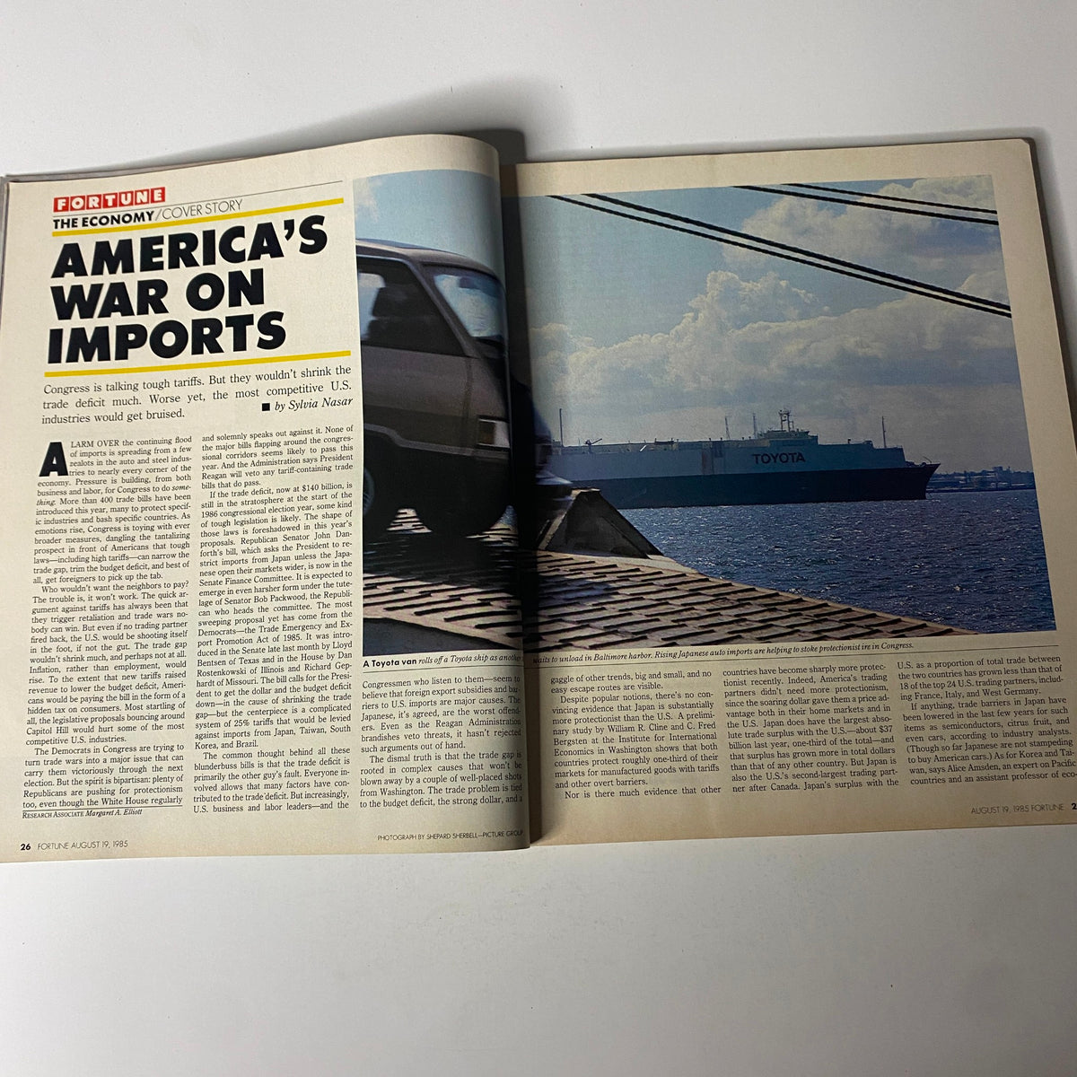 Inside spread of Fortune Magazine August 19, 1985 highlighting the cover story 'America’s War on Imports' alongside a photo of a vehicle and a cargo ship, discussing U.S. trade policy issues.