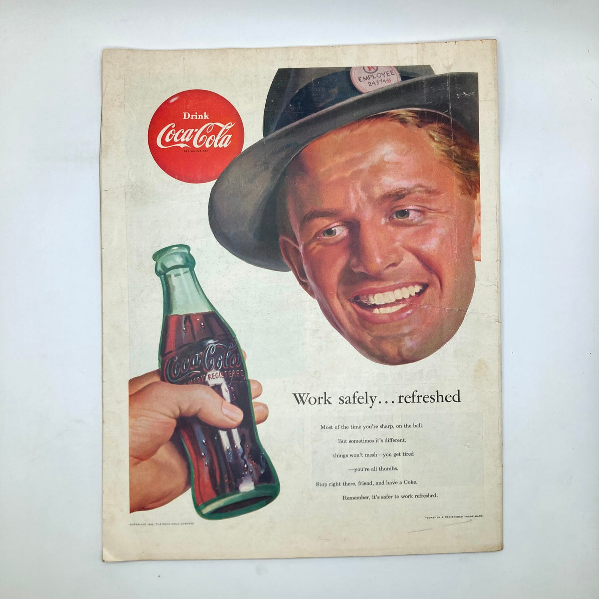 Advertisement page from the Saturday Evening Post Magazine December 28 1953 featuring a Coca-Cola ad with a smiling man in a hat holding a Coke bottle, illustrating vintage marketing appeal.