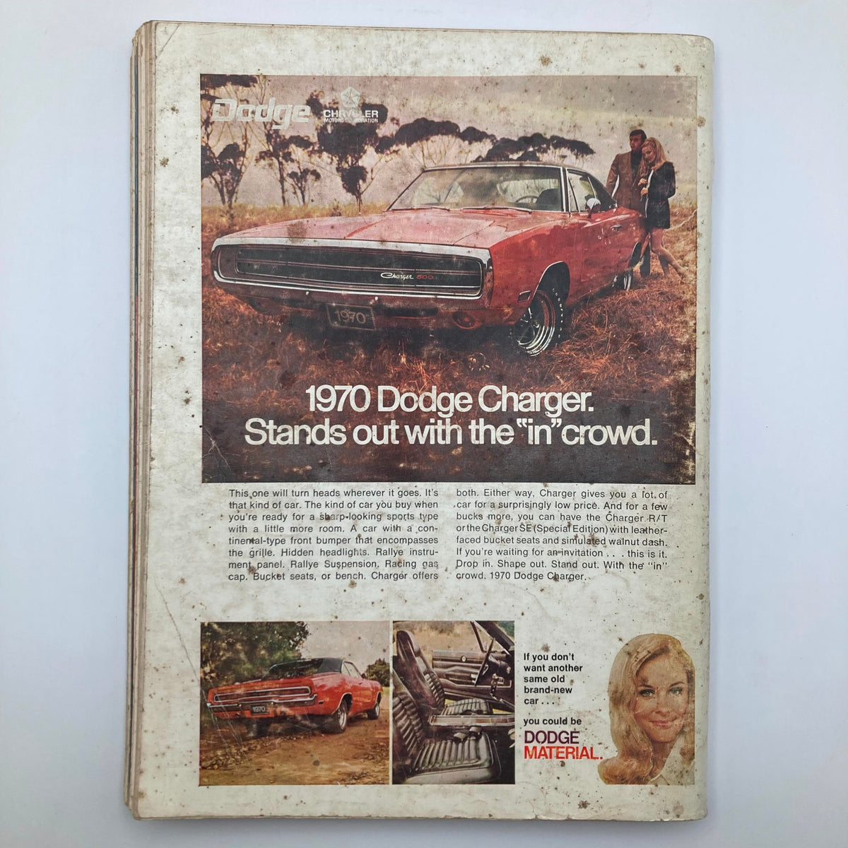 1970 Dodge Charger advertisement featured in VTG Playboy Magazine December 1969, showcasing the car with a classic design, surrounded by a scenic outdoor setting.