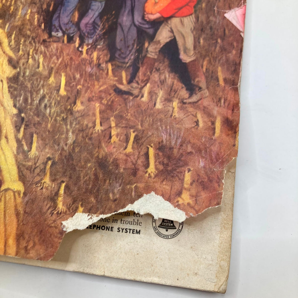 Close-up detail of the Saturday Evening Post Magazine cover from November 1, 1952, highlighting wear and tear including a torn edge, depicting the Jack-o-Lantern artwork by John Falter.