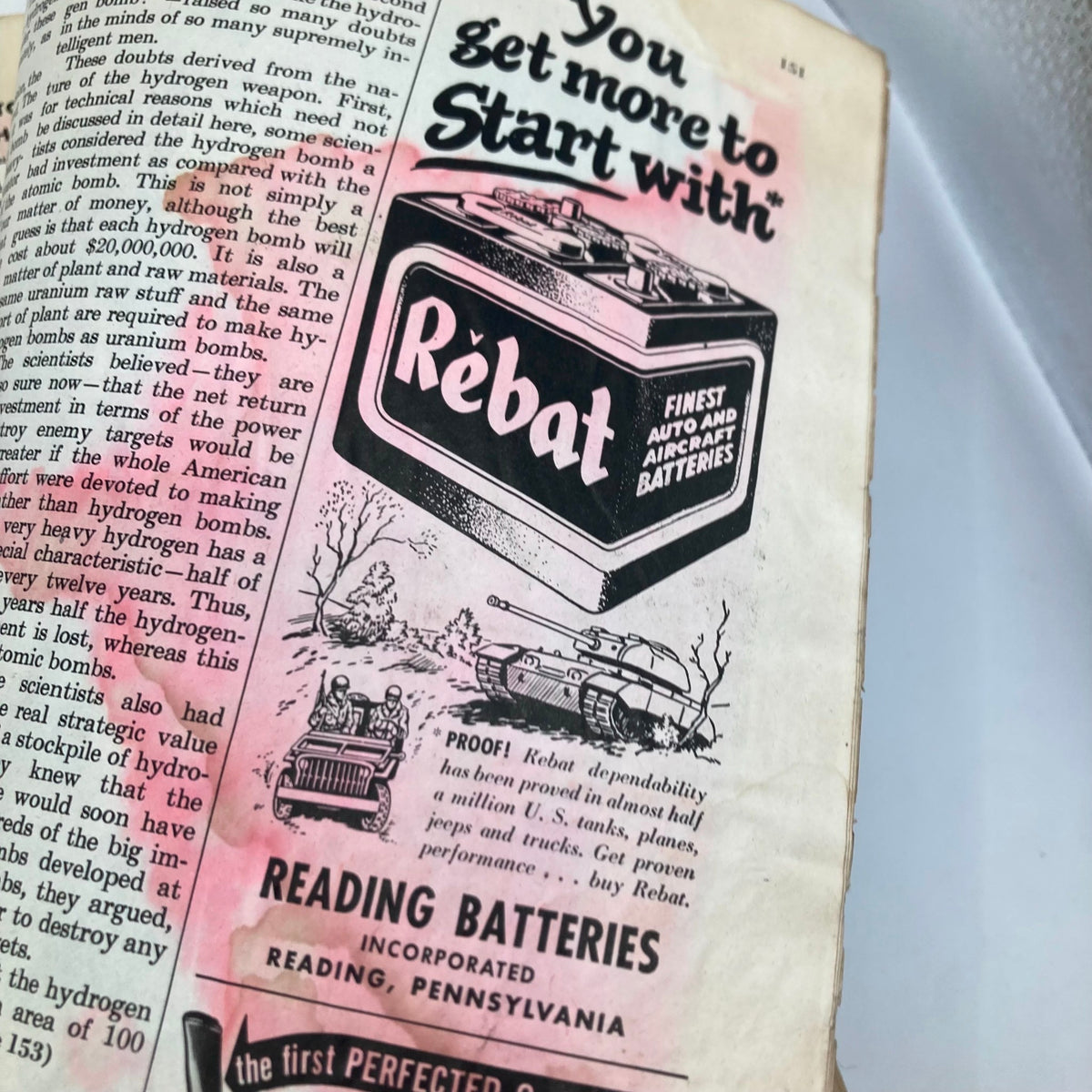 Interior page of the Saturday Evening Post Magazine October 25 1952, showcasing an advertisement for Rebat batteries, highlighting their reliability with an illustrated scene of military vehicles.