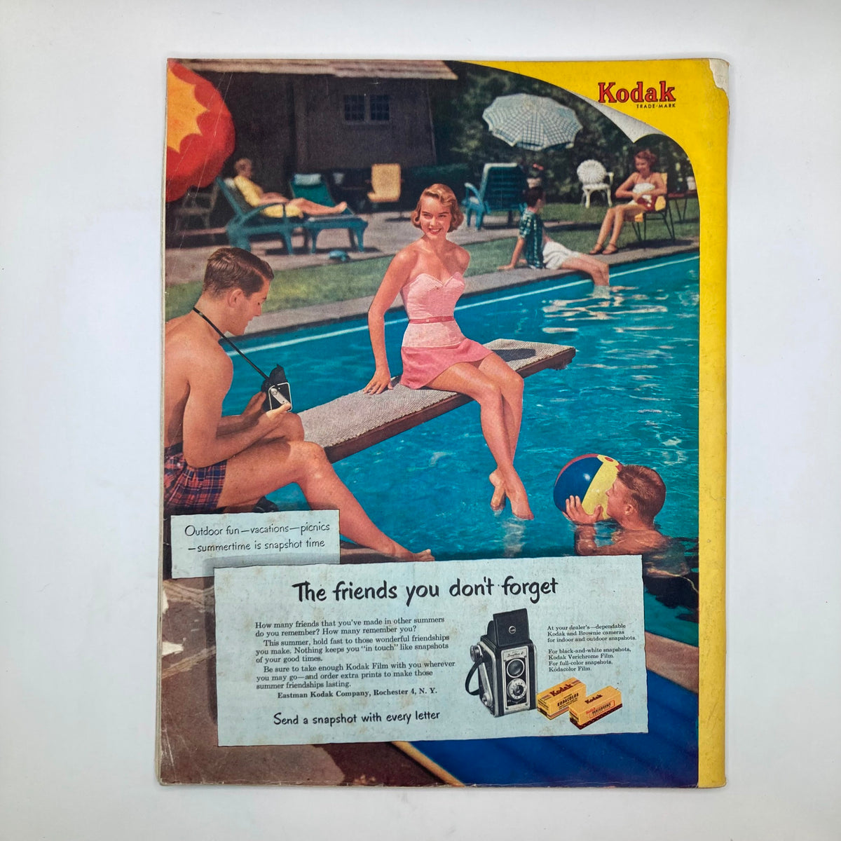 Cover of the Saturday Evening Post Magazine from June 7, 1952, featuring a vibrant summer pool scene with a woman in a pink swimsuit sitting on a diving board, while a man photographs her with a camera; the image evokes nostalgic mid-century Americana.