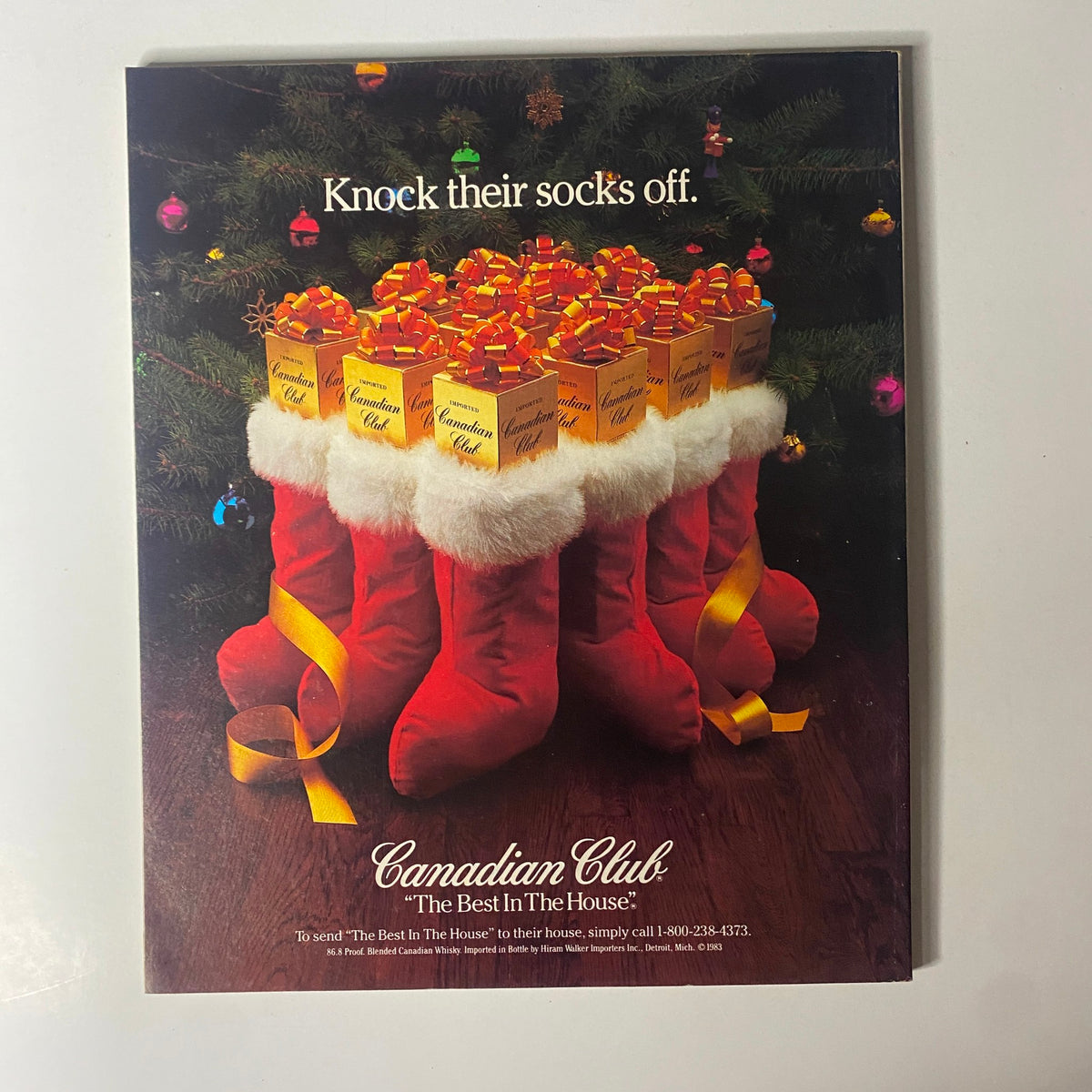 Vintage advertisement for Canadian Club whiskey featuring festive holiday stockings filled with gifts, titled 'Knock their socks off.' Part of the December 26, 1983 issue of Fortune Magazine.