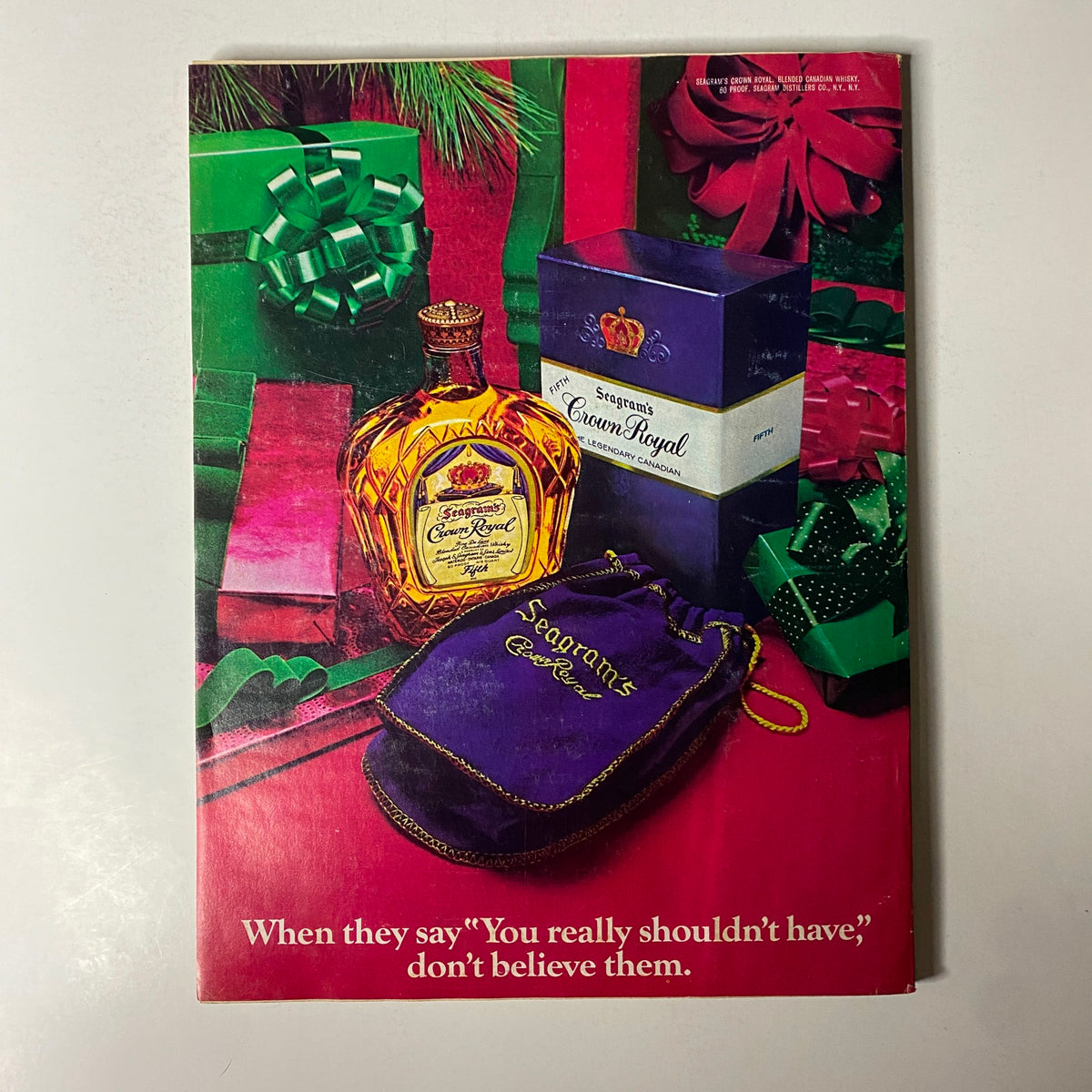 December 1976 Esquire Magazine cover featuring Seagram's Crown Royal whiskey bottle alongside festive green and red gift boxes, capturing a vintage holiday theme.