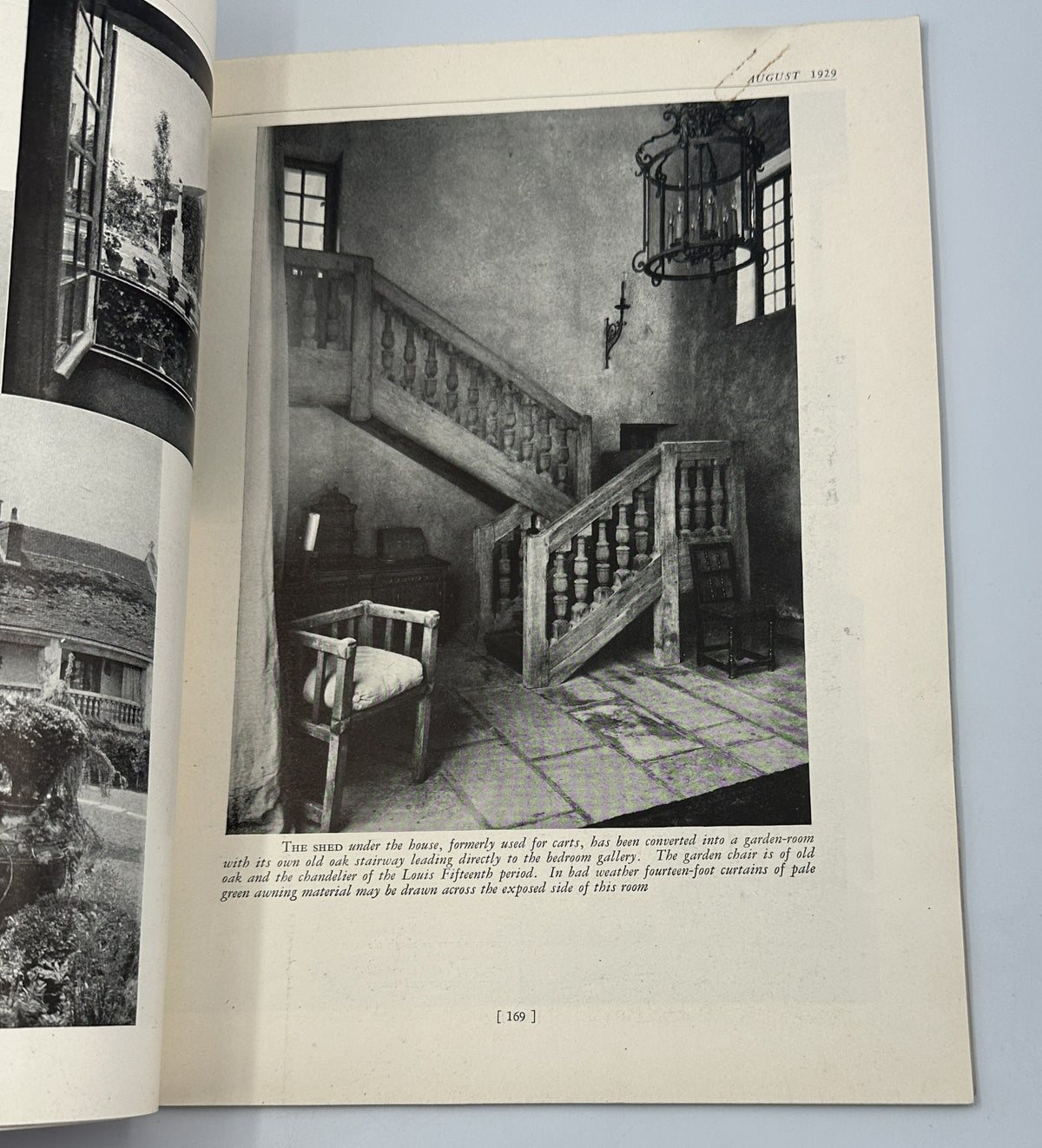 Interior staircase photograph from House Beautiful Magazine August 1929, showcasing a rustic design with wooden banisters and a unique chandelier.