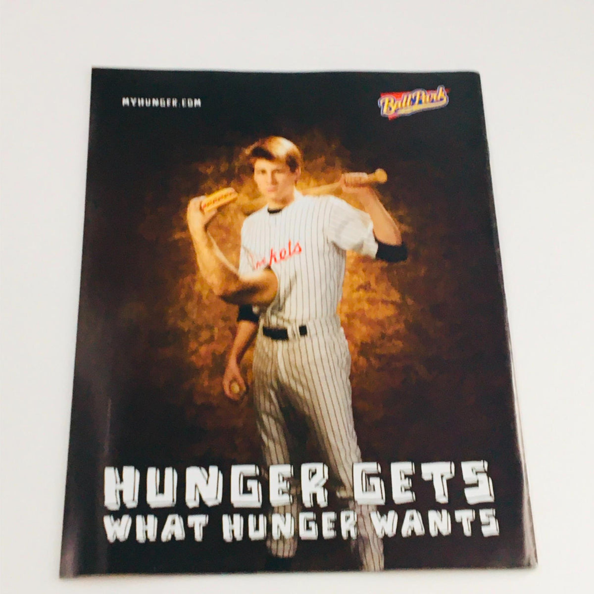 Advertisement from Mad Magazine featuring a baseball player holding hot dogs with the tagline 'Hunger Gets What Hunger Wants', showcasing humor and nostalgia.