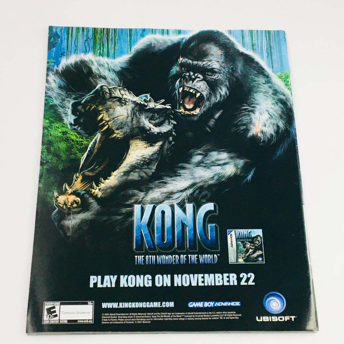 Back cover of Mad Magazine December 2005 No. 460 featuring a promotion for the video game Kong, depicting fierce gorillas in an action scene with a call to play on November 22.