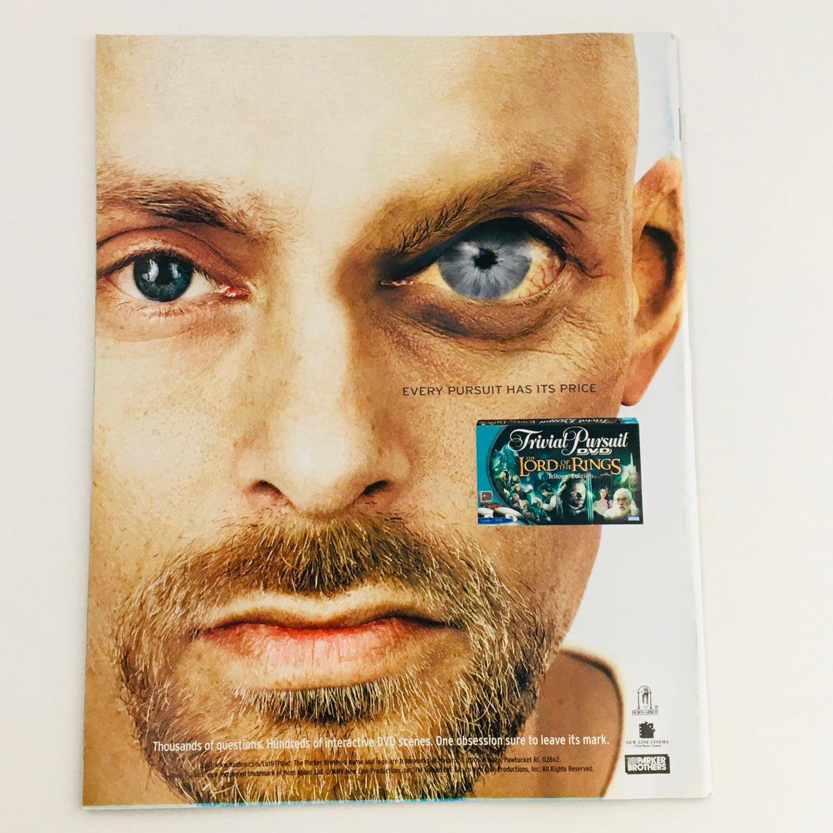 Back cover of Mad Magazine April 2005 No. 452 showcasing a striking close-up of a man's face with a unique eye, promoting Trivial Pursuit: Lord of the Rings.