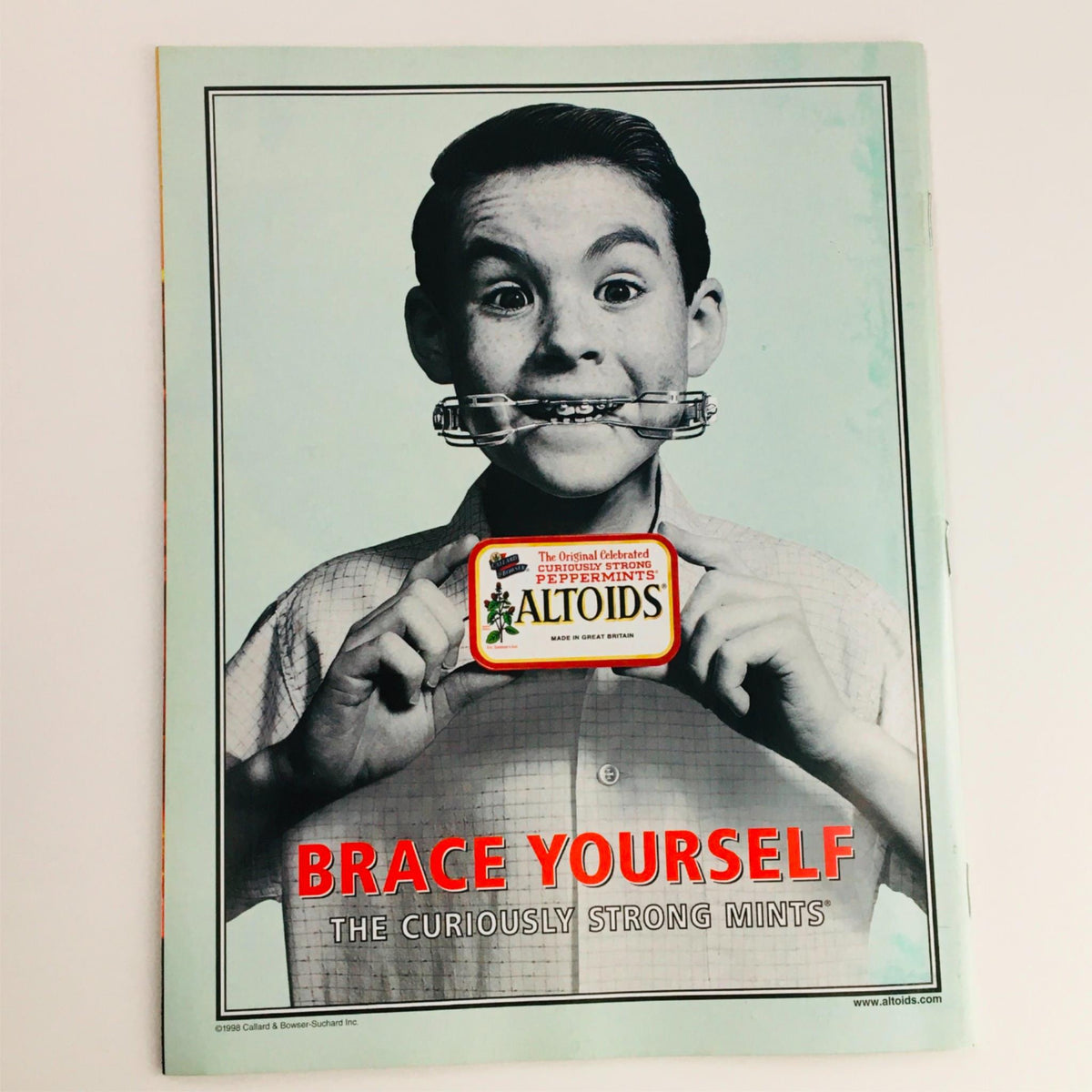 Back cover of Mad Magazine December 2001 No. 412 featuring a vintage advertisement for Altoids with a young boy holding a tin of mints and a playful expression.