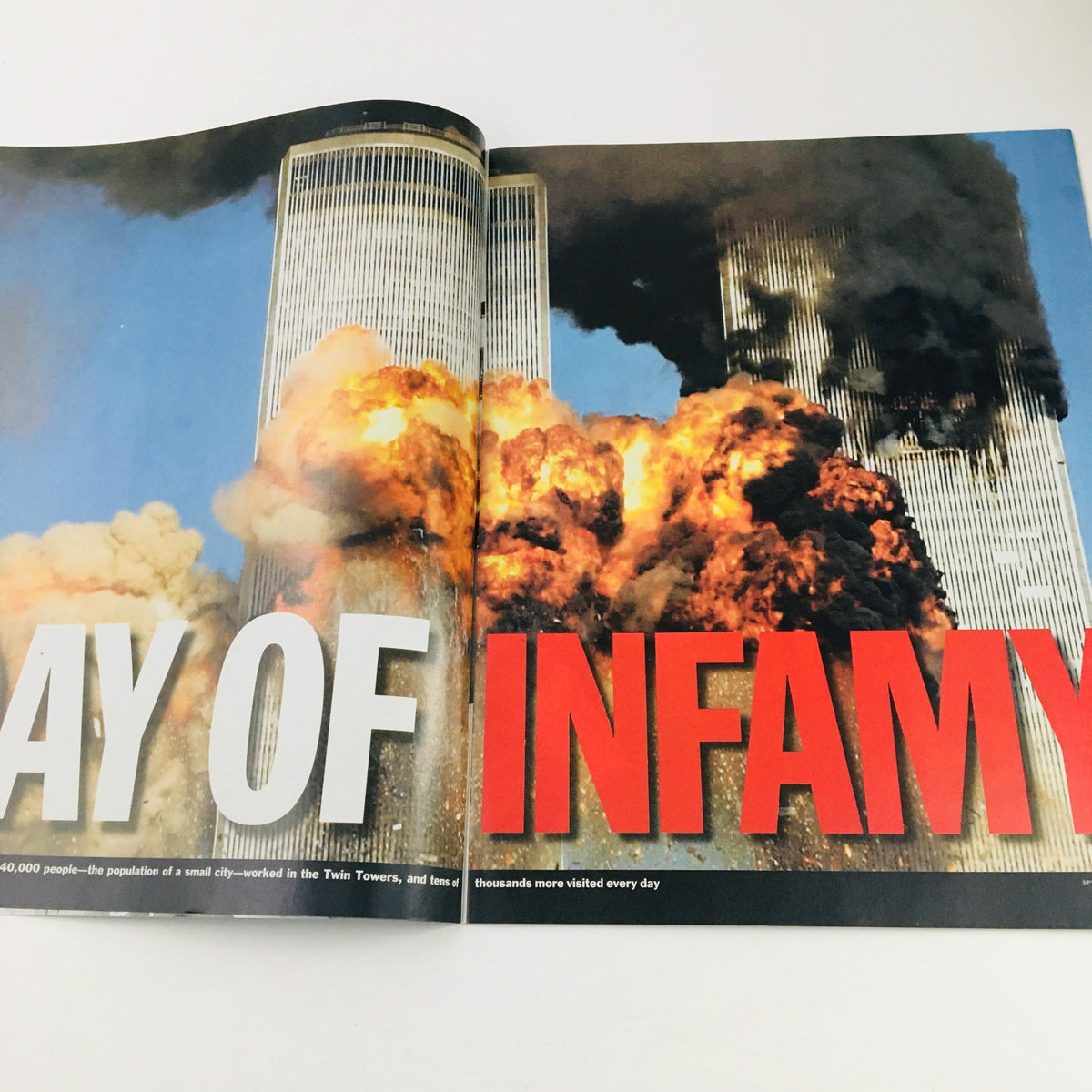 Time Magazine September 11 2001 Day of Infamy showcasing an inside spread with bold text reading 'DAY OF INFAMY' alongside images of the burning Twin Towers.