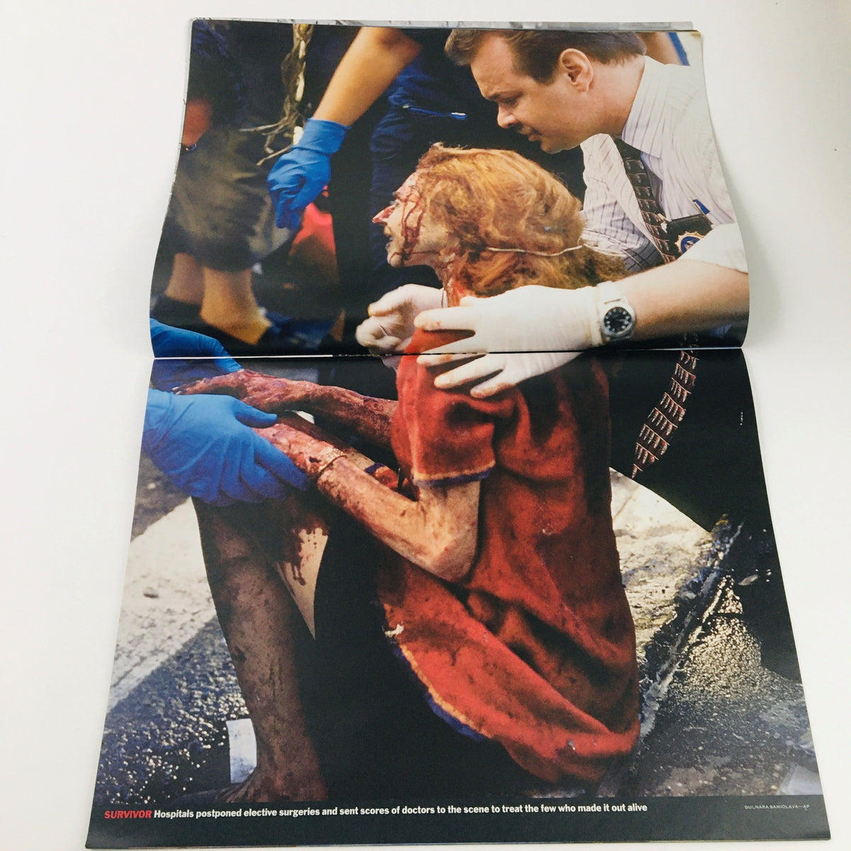 Time Magazine September 11 2001 Day of Infamy illustrating a poignant moment with a survivor being treated after the attacks, highlighting the human impact of the events.