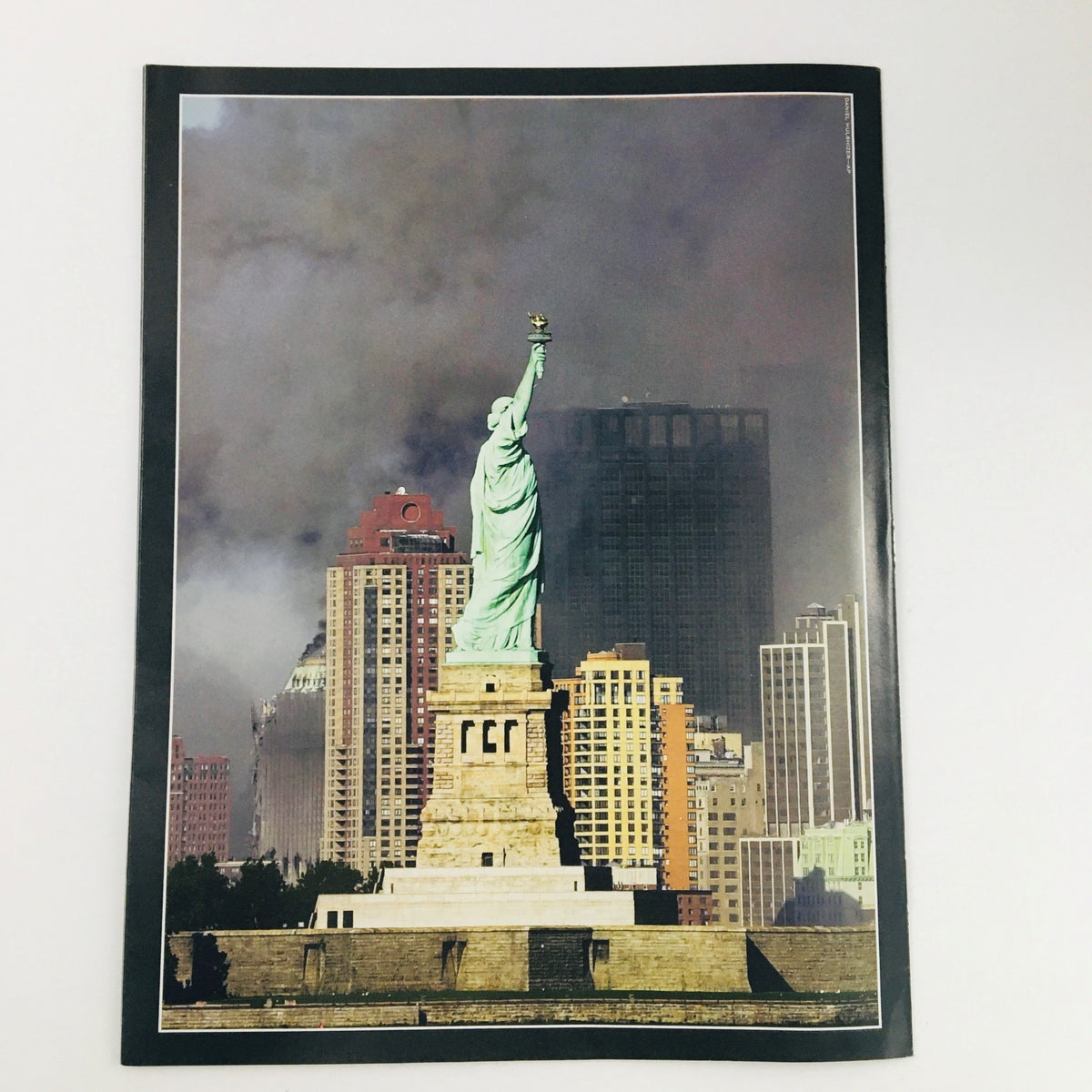 Time Magazine September 11 2001 Day of Infamy depicting the Statue of Liberty amidst smoke and destruction, reflecting the impact of the Twin Towers tragedy.