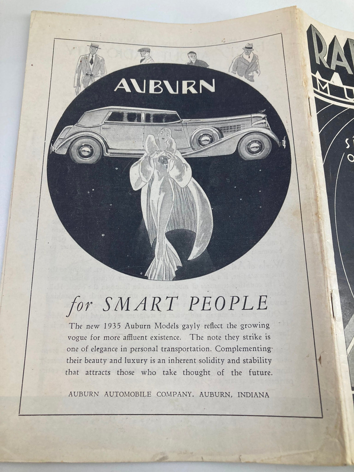 Advertisement page in the 1935 Radio City Music Hall Show Place of the Nation program promoting Auburn automobiles with an elegant design illustration.