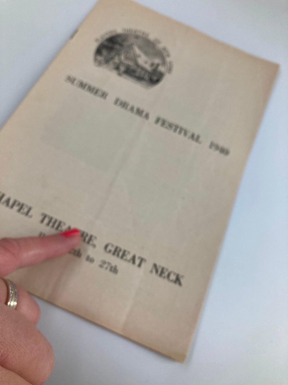 Detail view of the front cover of the 1940 Summer Drama Festival Playbill for A Man's House, at Chapel Theater, Great Neck, featuring a finger pointing to the text.