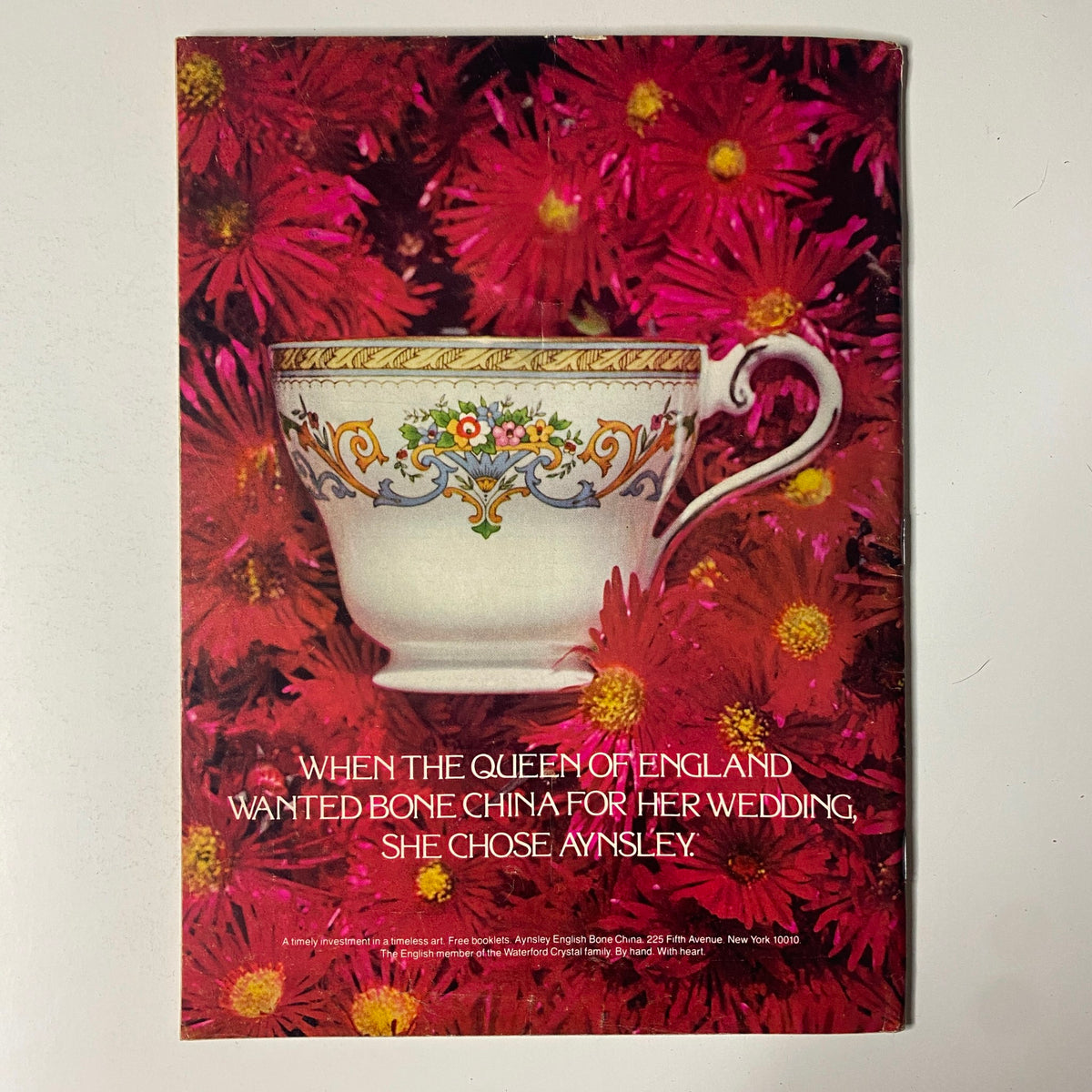 Vintage advertisement for Aynsley English Bone China in The New Yorker Full Magazine July 25, 1977, showcasing an elegant teacup against a backdrop of vibrant pink flowers.