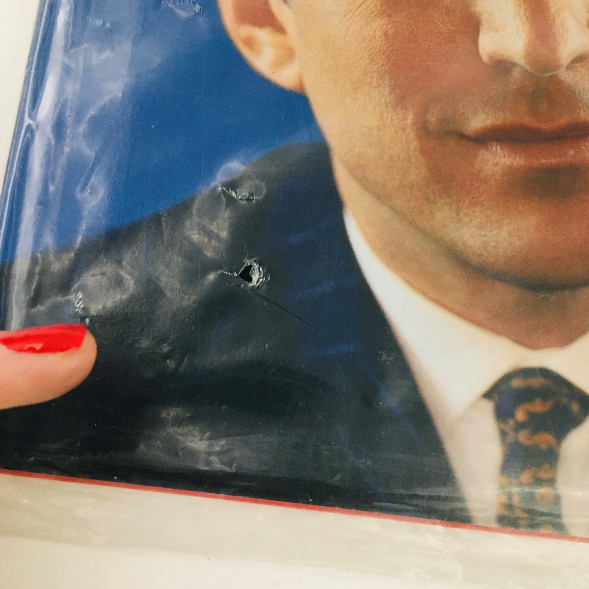 Detailed view of the George Magazine May 2001 Farewell Issue cover, showcasing John Kennedy's portrait and the original packaging with slight damage, emphasizing its vintage appeal.