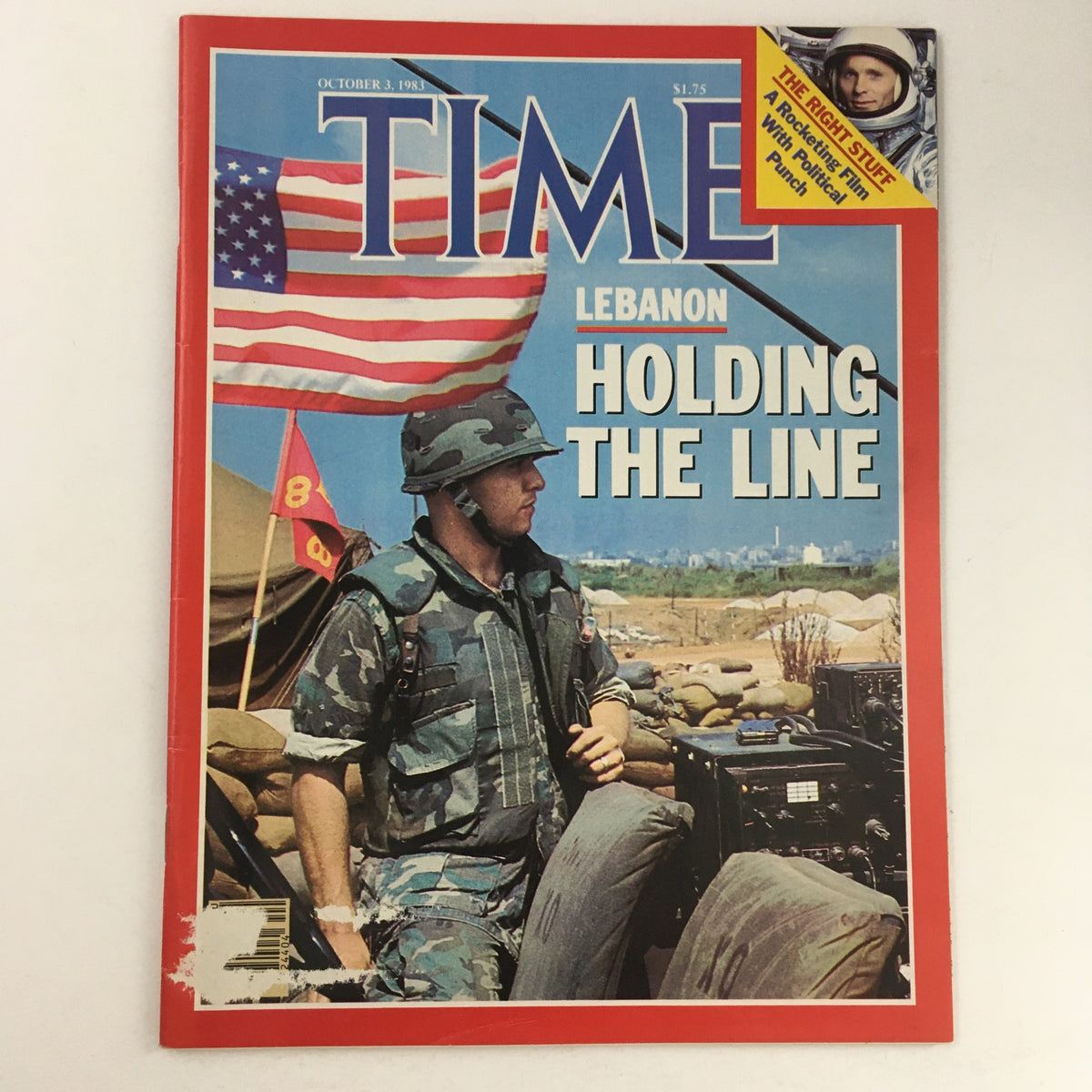 Cover of Time Magazine from October 3, 1983, Vol 122 #14 featuring the title 'Lebanon Holding The Line'. The cover depicts a soldier in camouflage gear and a helmet, with an American flag waving in the background, representing a critical moment during the Lebanese Civil War.