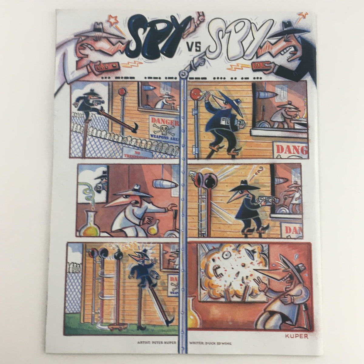Inside illustration from Mad Magazine November 1999 No. 387 showcasing a 'Spy vs. Spy' comic strip, highlighting the playful rivalry between two spies in a colorful and dynamic layout.