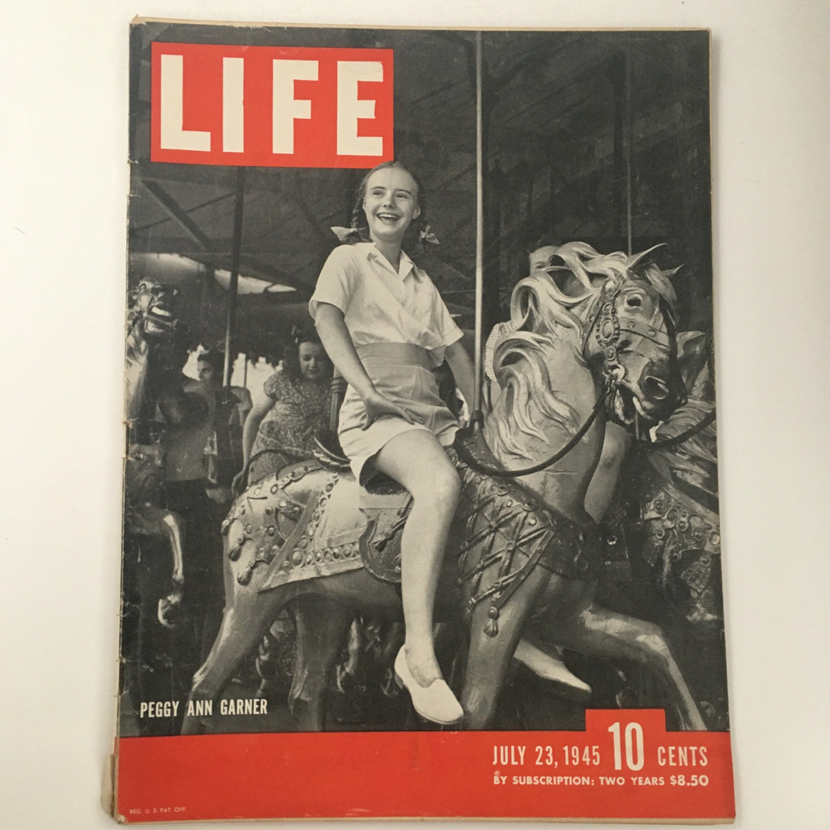 Life Magazine July 23 1945 featuring Peggy Ann Garner on a carousel ride, capturing a nostalgic moment of childhood joy from post-war America.