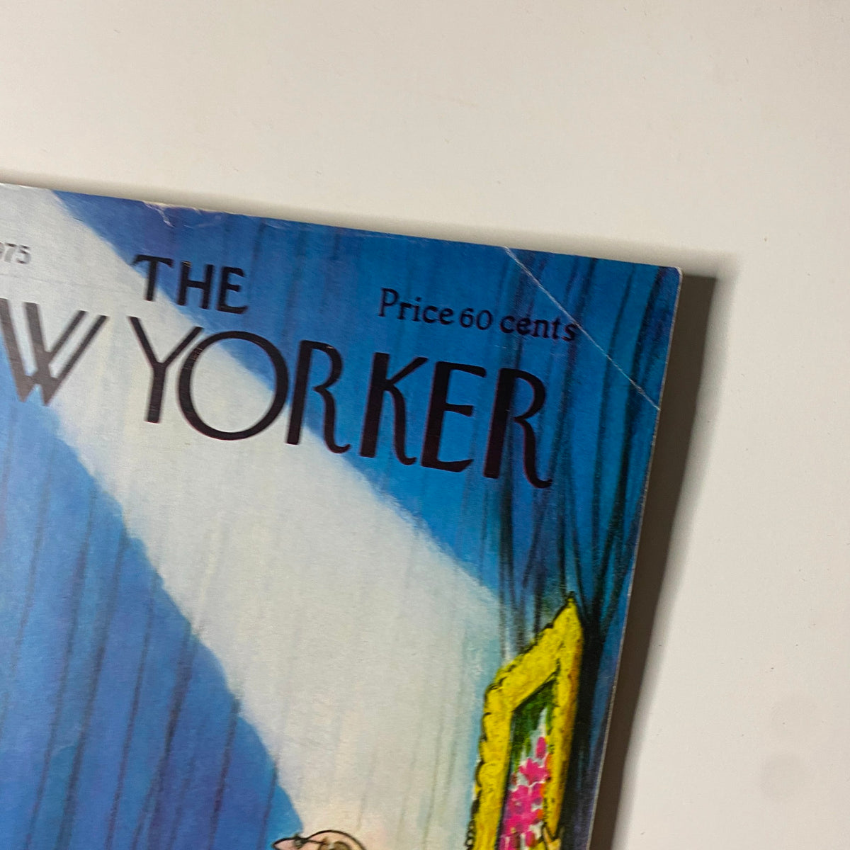 Close-up view of The New Yorker magazine cover from April 14, 1975, showcasing the title and price, with details of the vibrant background and artwork.
