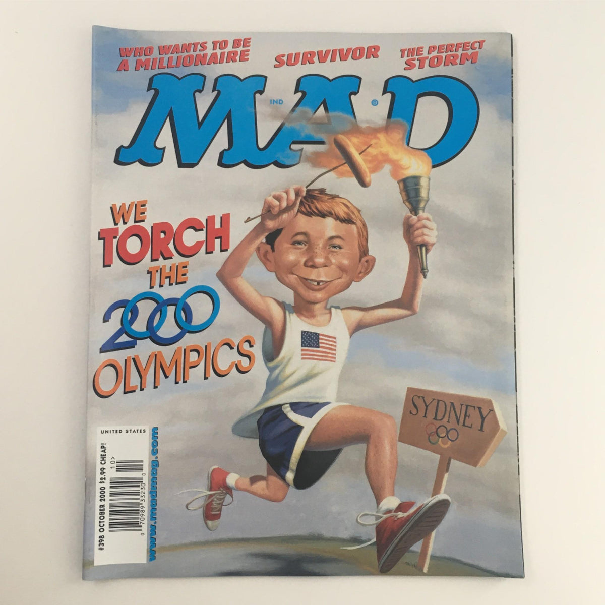 Cover of Mad Magazine October 2000 No. 398 featuring the headline 'We Torch The 2000 Olympics' with an illustrated character holding a torch, capturing the spirit of the Sydney Olympic Games.