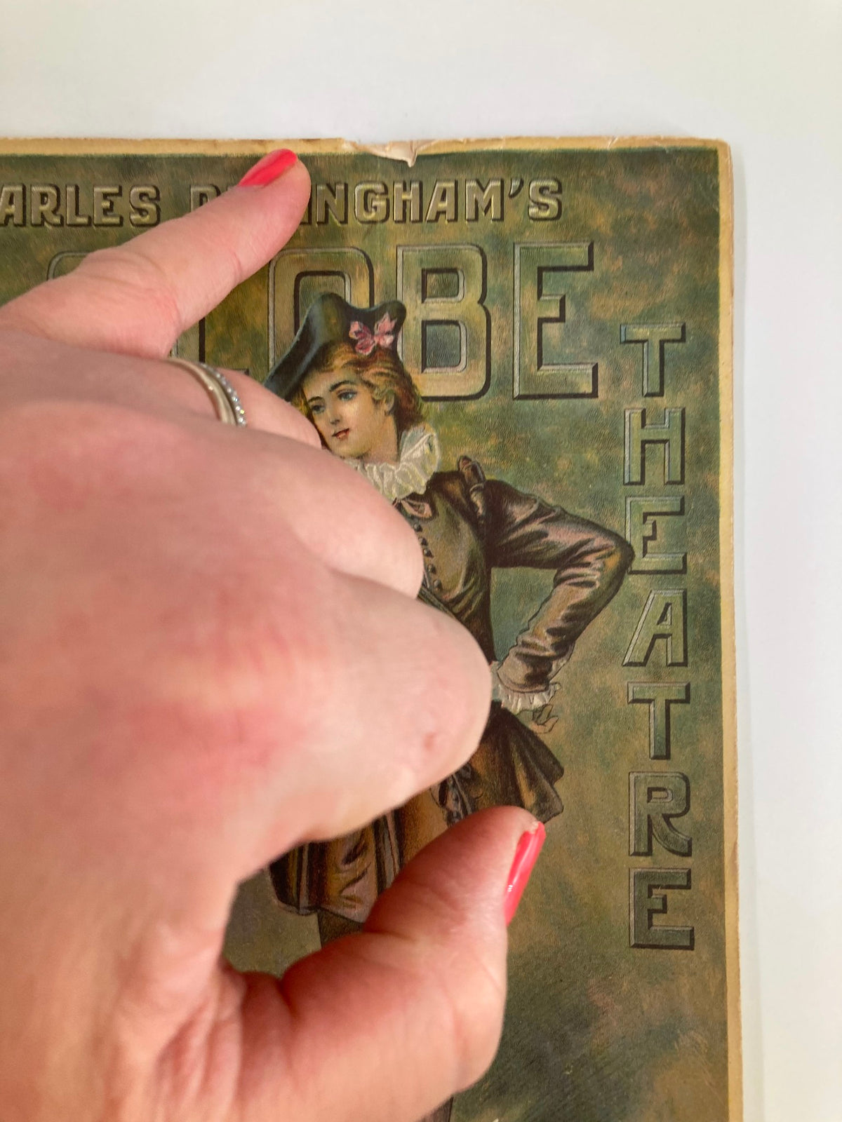 Detail view of the front cover of the 1913 Globe Theatre Playbill, highlighting the artwork and condition while featuring Montgomery & Stone and Elsie Janis in The Lady of the Slipper.