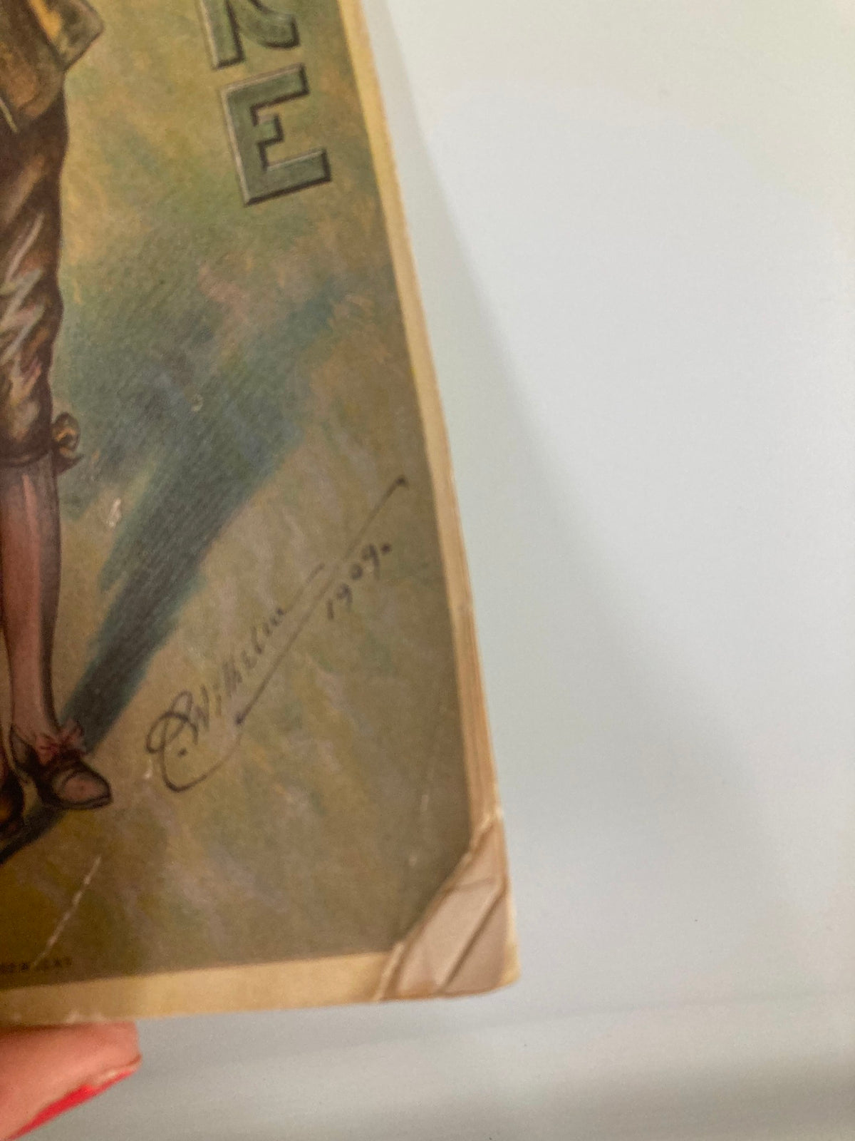 Close-up of the bottom corner of the 1913 Globe Theatre Playbill featuring Montgomery & Stone and Elsie Janis in The Lady of the Slipper, showing age-related wear.