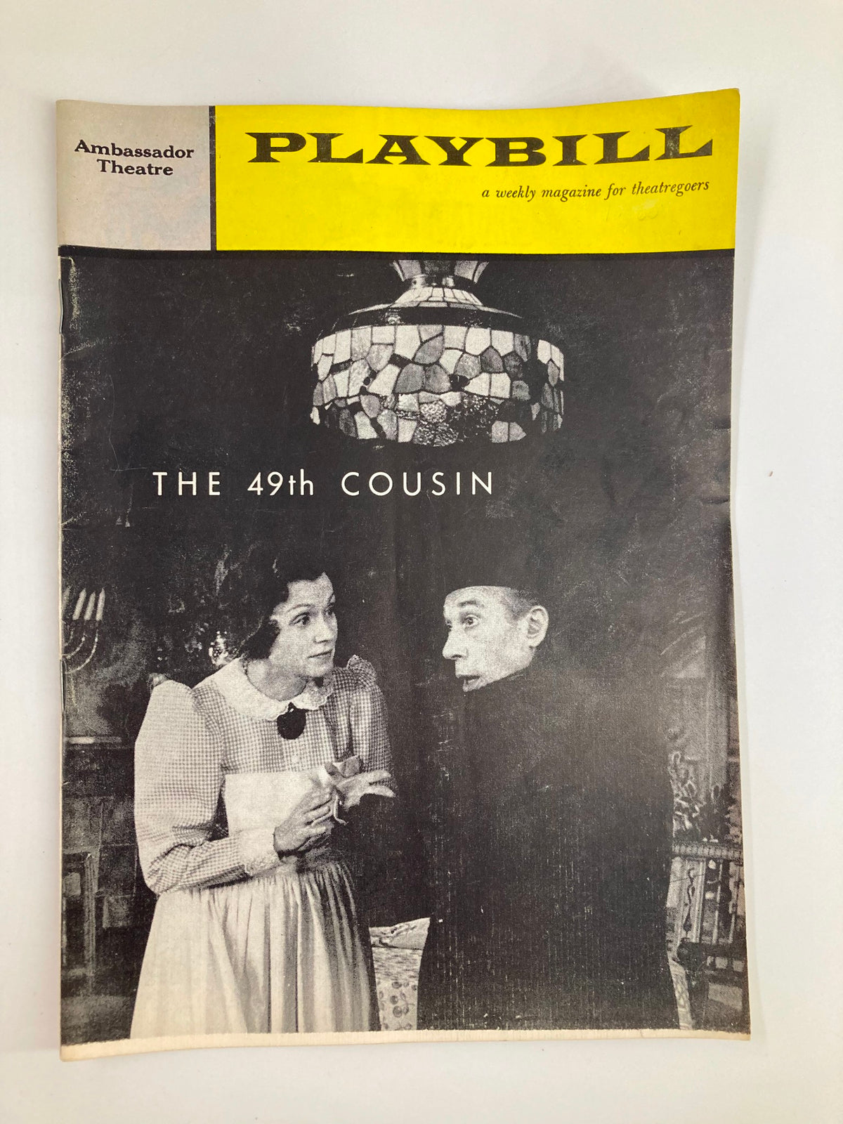 1960 Playbill for 'The 49th Cousin' featuring a black and white image of two characters in conversation at the Ambassador Theatre.