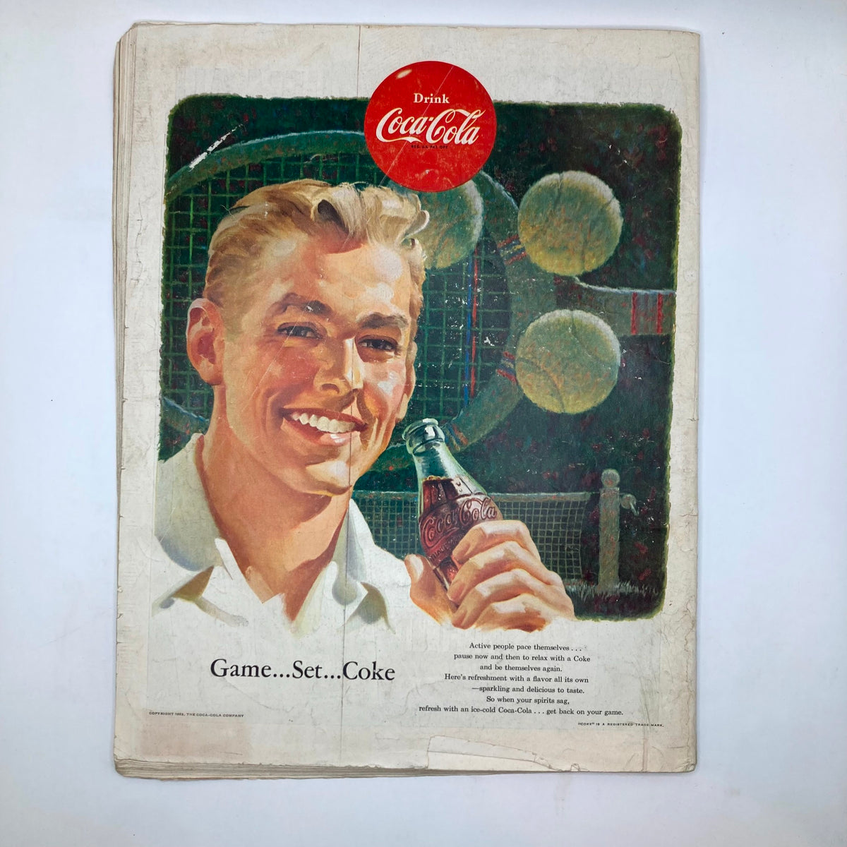 Back cover of Saturday Evening Post Magazine September 5 1953 featuring an advertisement for Coca-Cola with a smiling young man.