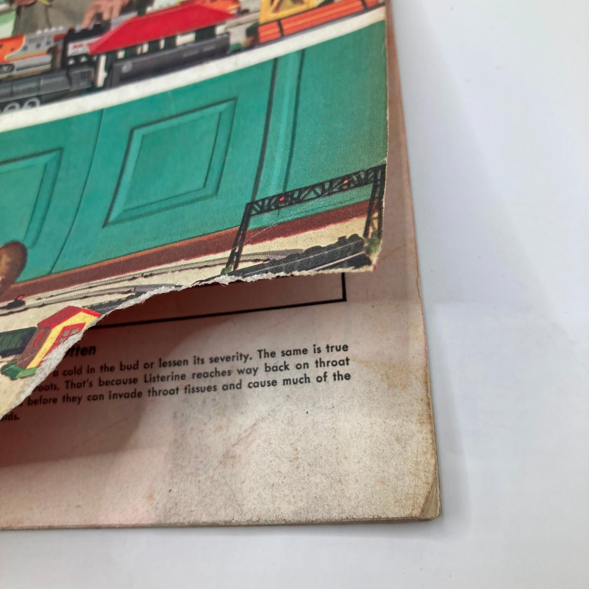 Close-up of the cover of Saturday Evening Post Magazine December 19, 1953 showing a corner tear and overall vintage wear, emphasizing the magazine's character and age.