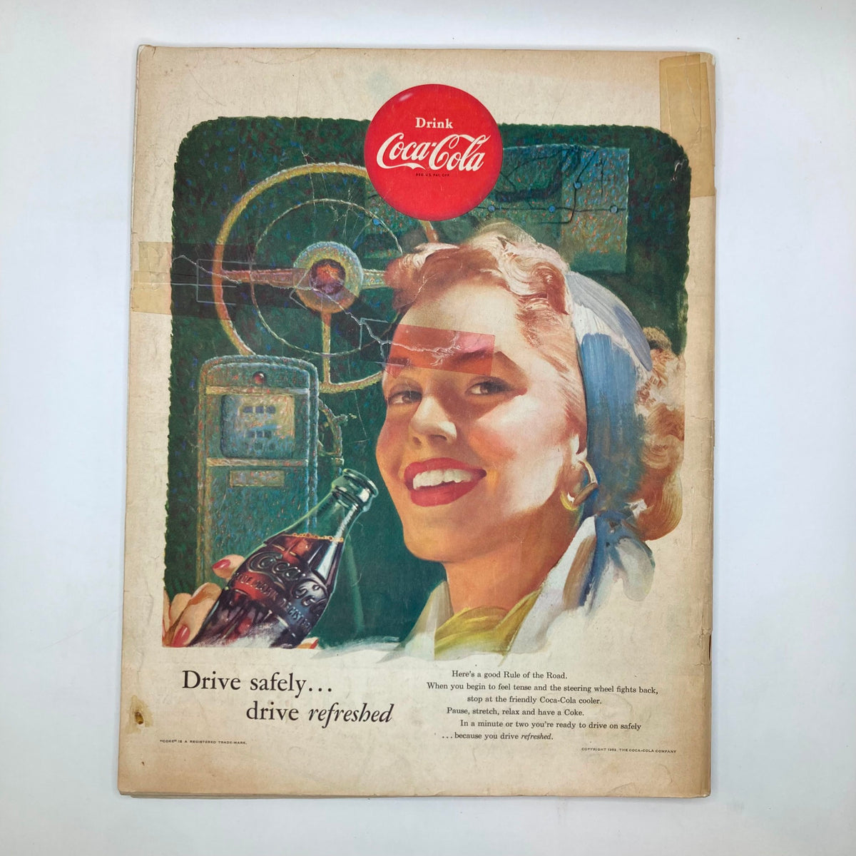 Cover of the vintage Coca-Cola advertisement with a smiling woman holding a Coke bottle, promoting safe driving, from the Saturday Evening Post Magazine June 13, 1953.