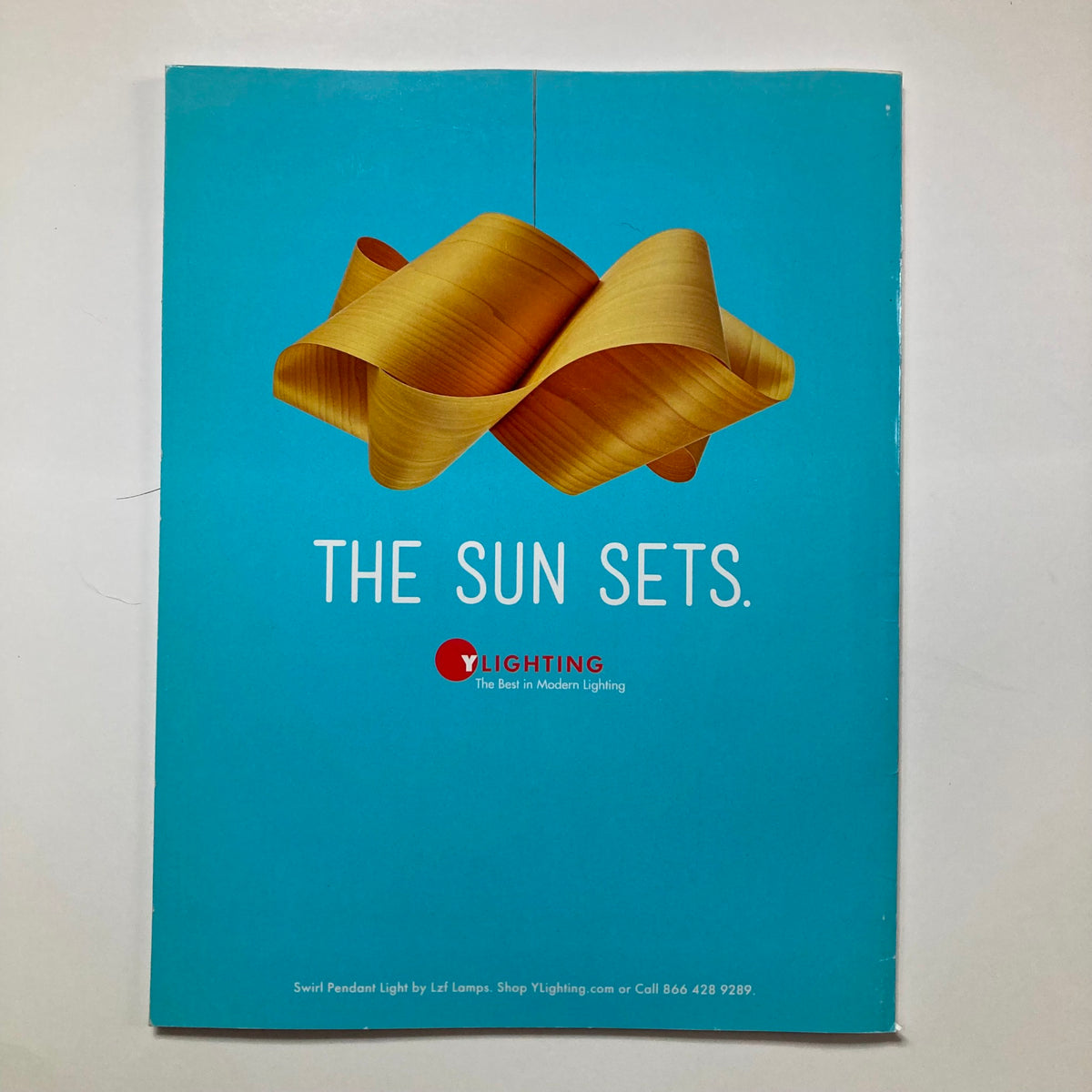 Back cover of Atomic Ranch Magazine Spring 2017 featuring a stylish lighting advertisement with the tagline 'THE SUN SETS.'