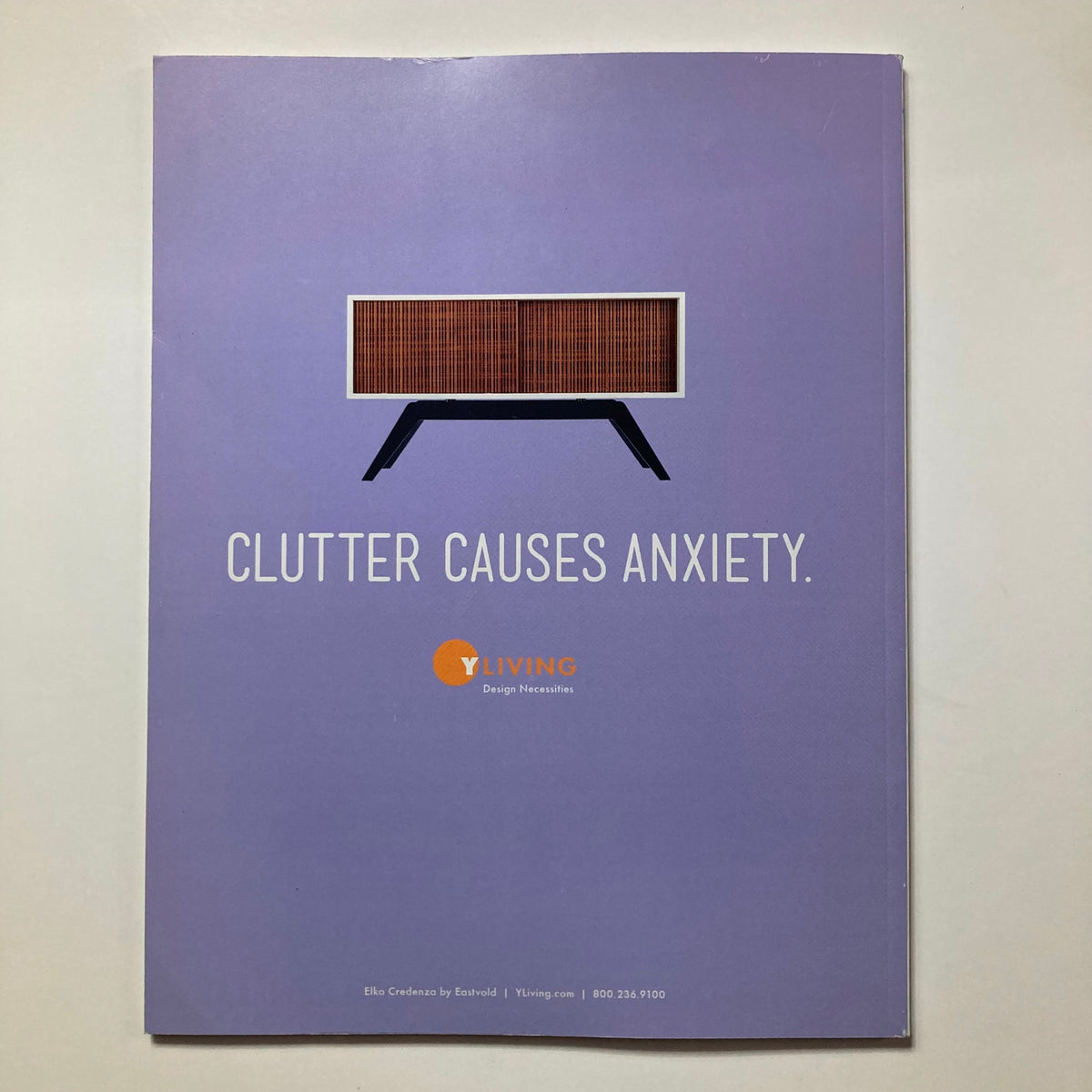 Cover of Atomic Ranch Magazine Spring 2015 featuring a purple background with the phrase 'CLUTTER CAUSES ANXIETY' and an image of a sleek, modern credenza, highlighting mid-century design aesthetics.