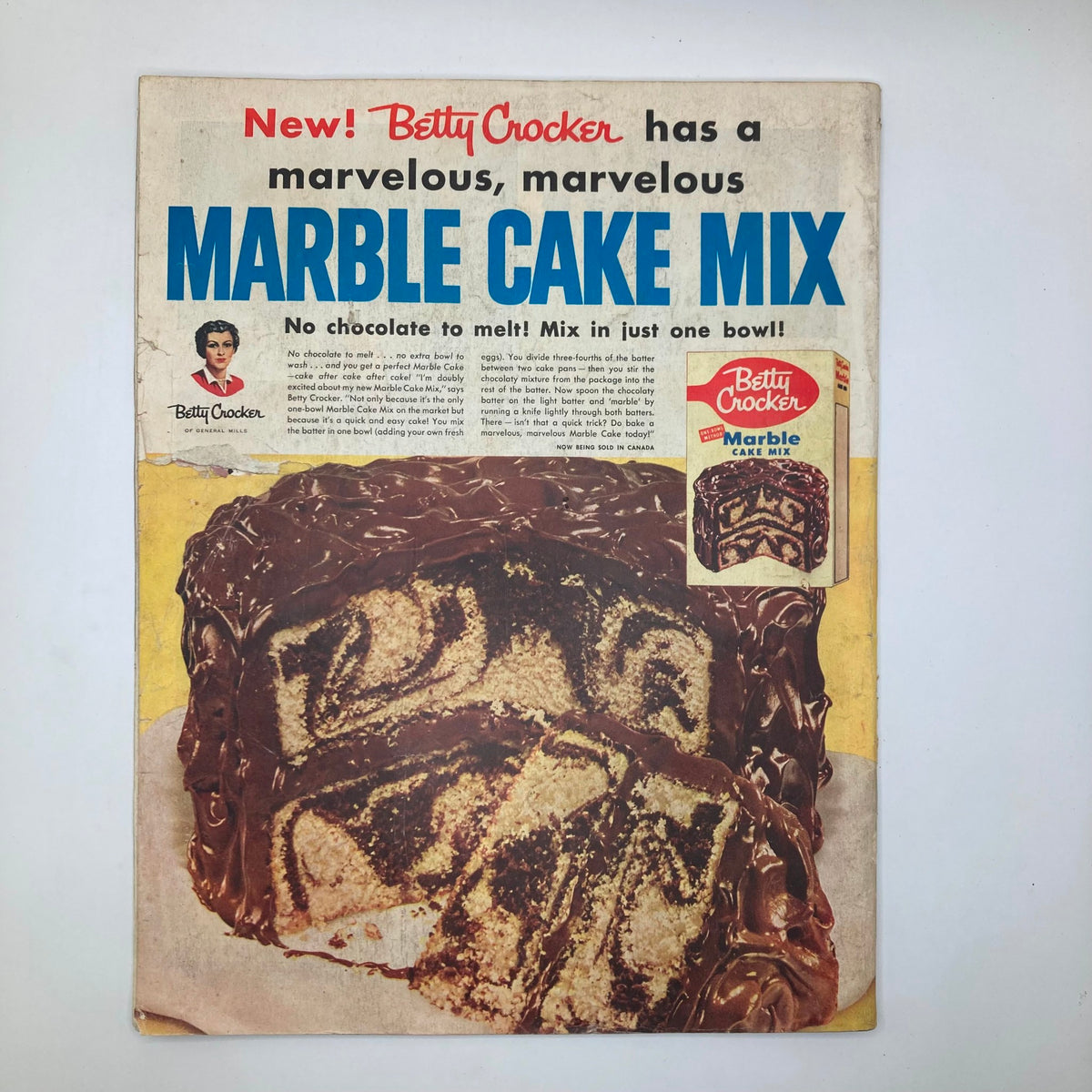 Advertisement for Betty Crocker's Marble Cake Mix featured in the Saturday Evening Post Magazine, showcasing a mouthwatering cake with a rich chocolate frosting, highlighting convenience in baking.