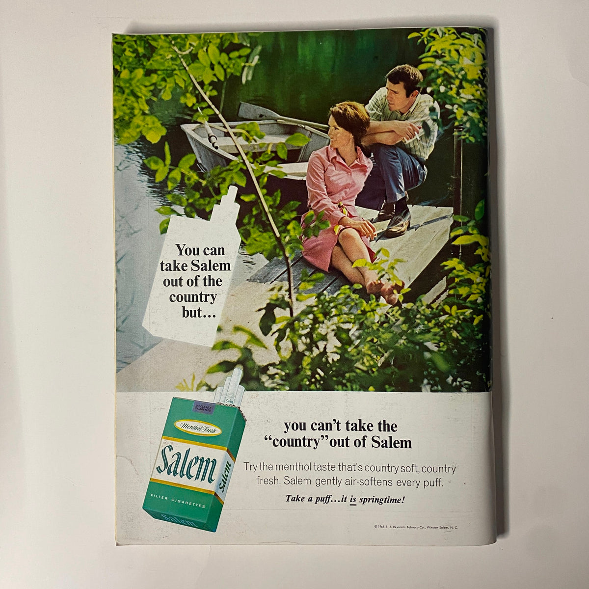 Vintage advertisement for Salem cigarettes from the February 1969 issue of Playboy Magazine, illustrating a couple by the water with a bottle of Salem and emphasizing its fresh menthol taste.