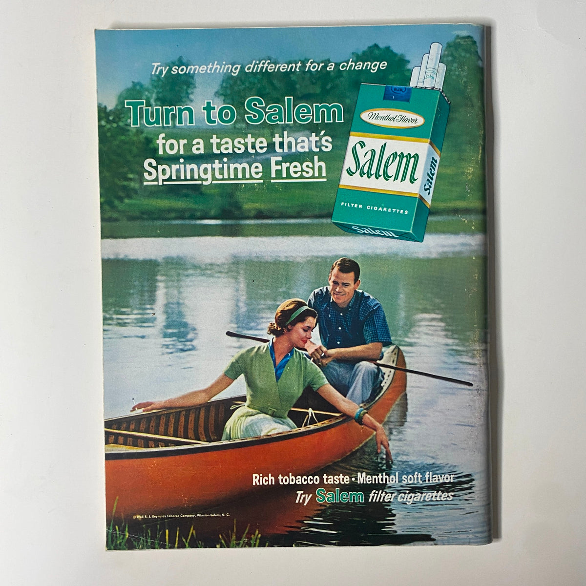 Vintage advertisement for Salem cigarettes from Playboy Magazine February 1966 featuring a couple in a canoe by a lake.