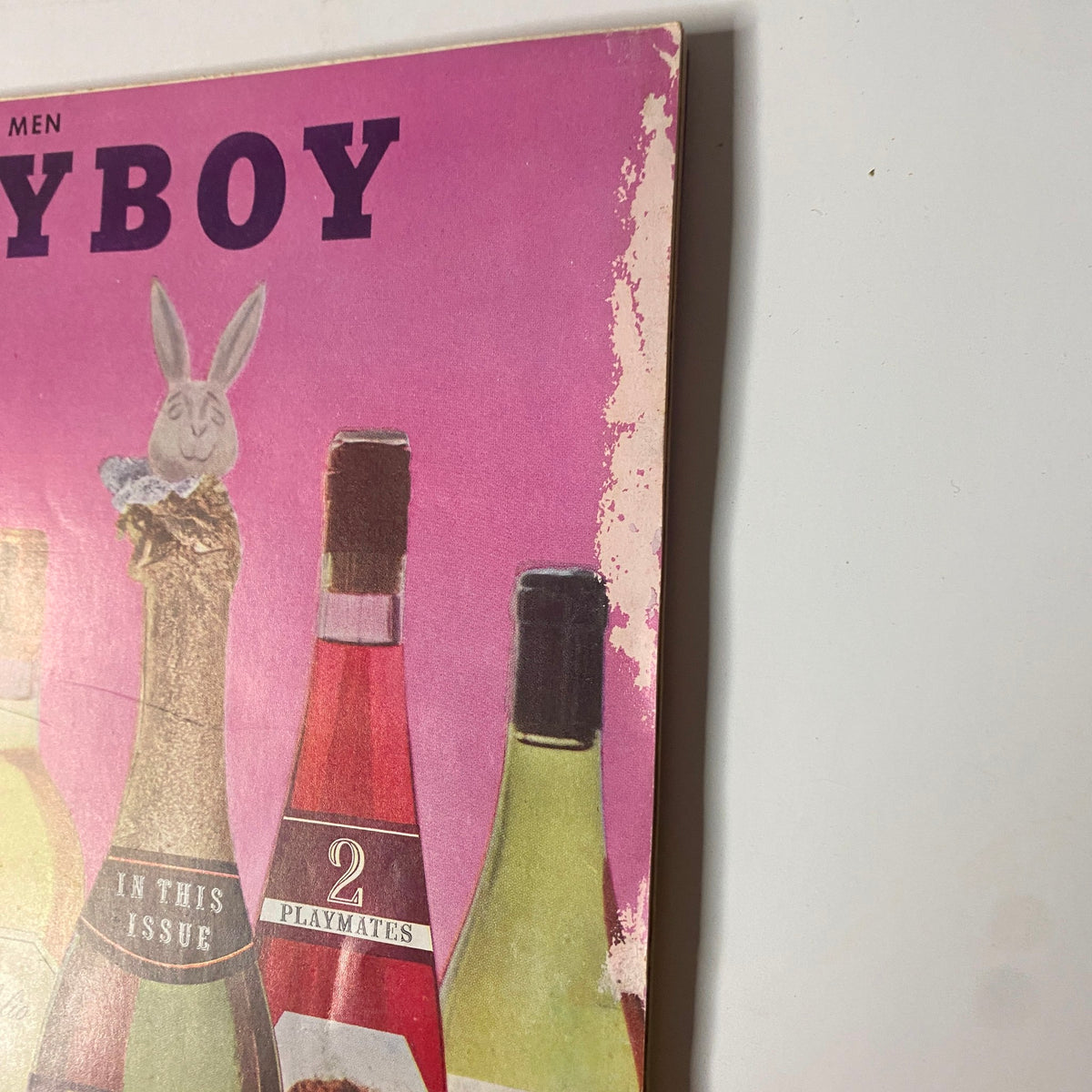 Detail of the October 1958 Playboy Magazine cover, showcasing the wine bottles and the unique artwork, emphasizing its vintage appeal and significance for magazine collectors.