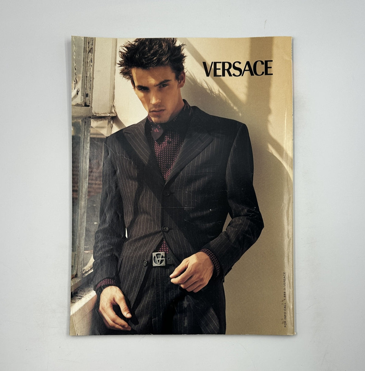 Image from George Magazine March 1999 displaying a male model in a Versace suit, emphasizing high fashion and style in the context of the magazine.