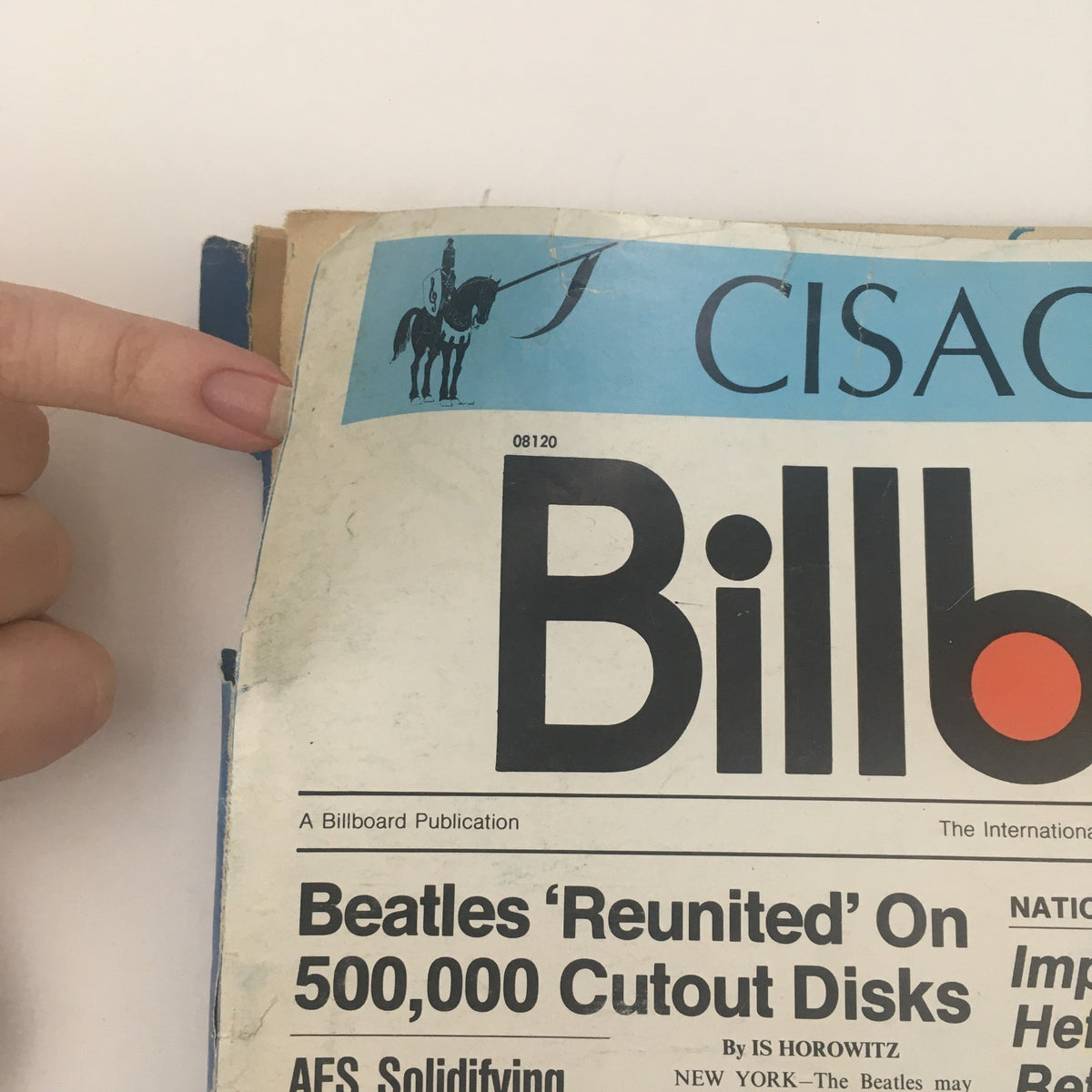 Detail of the Billboard Newspaper logo from November 6, 1976, featuring the headline 'Beatles Reunited On 500,000 Cutout Disks,' reflecting the vibrant music scene of the era.
