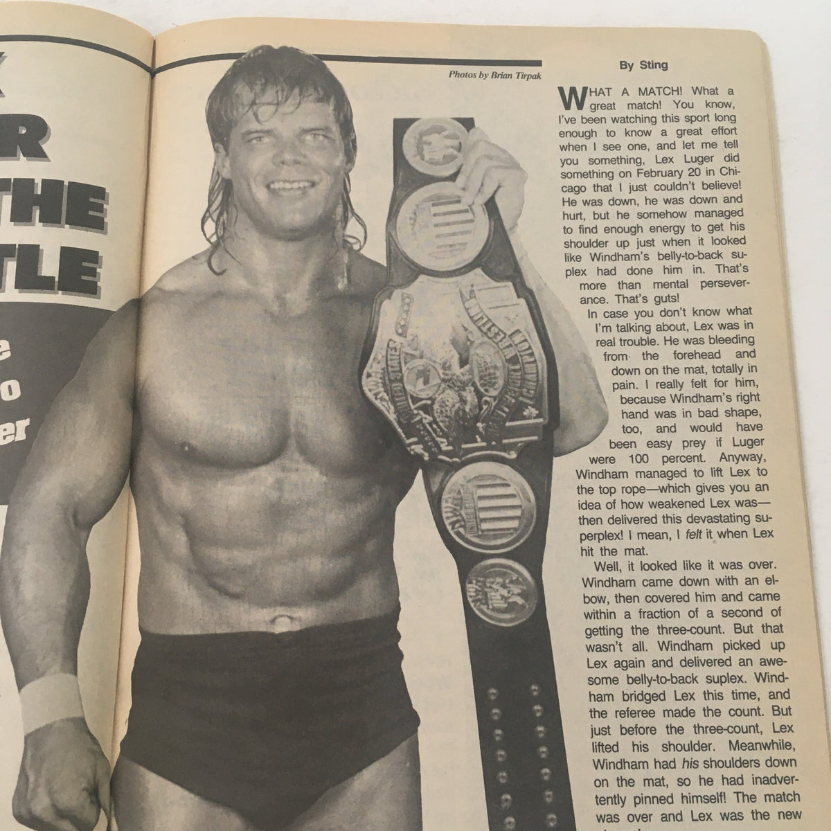 The Wrestler Magazine June 1989 image of Lex Luger showcasing his wrestling championship belt, highlighting his success in the ring.