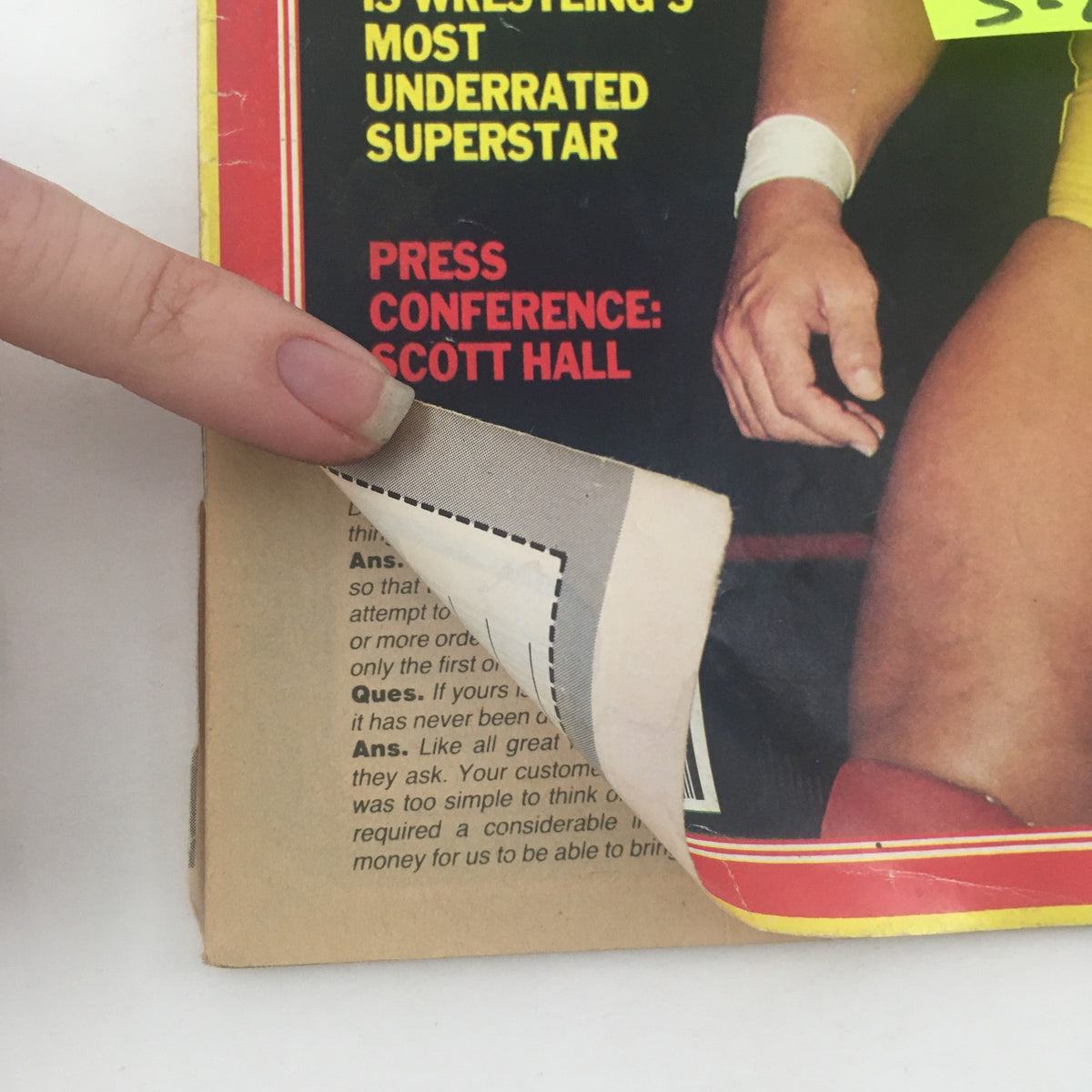 Folded corner of Pro Wrestling Illustrated June 1986 showing Scott Hall's press conference headline with a promotional tag, illustrating the magazine's content.